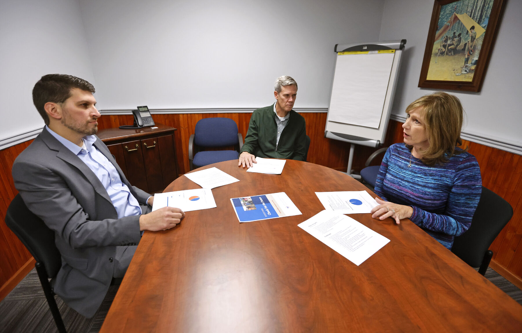 Wendy Knight (right) speaks with Carl Bobis (left), scout executive and CEO at the Northeast Iowa Council of Boy Scouts of America; and Matt Tompkins (middle), past president at Northeast Iowa Council of Boy Scouts of America.    PHOTO CREDIT: Jessica Reilly