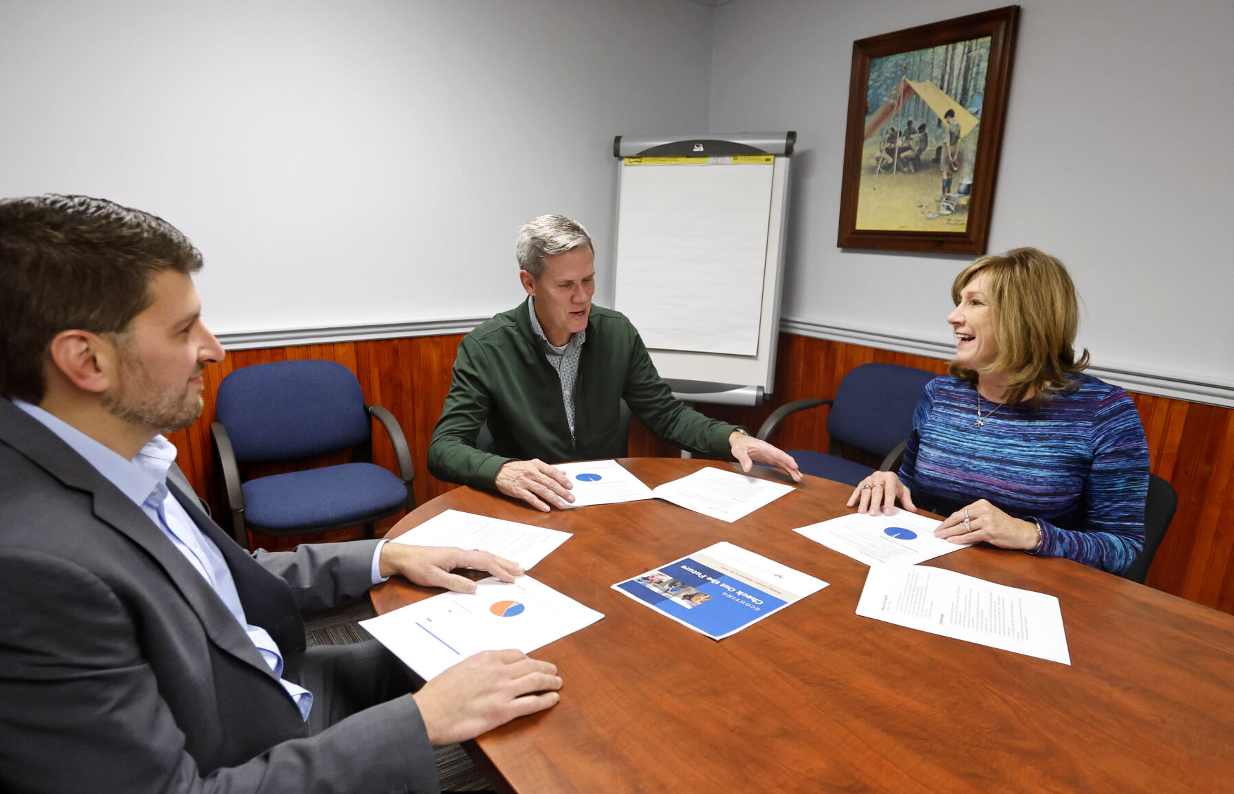 Wendy Knight (right), founder/collaborative strategist at Focus Forward, speaks with Carl Bobis (left), scout executive and CEO at the Northeast Iowa Council of Boy Scouts of America, and Matt Tompkins (middle), past president at Northeast Iowa Council of Boy Scouts of America, in Dubuque.    PHOTO CREDIT: Jessica Reilly