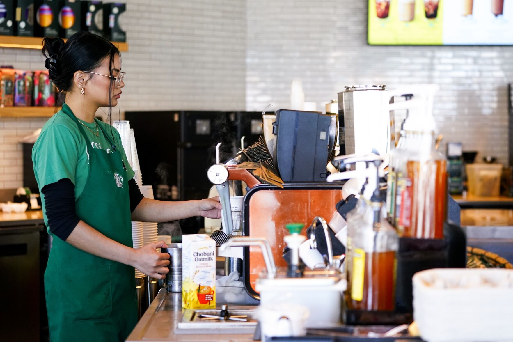 File - Nicole Lipa prepares a drink at a Starbucks location, June 28, 2023, in Seattle. On Friday, the U.S. government issues its November jobs report. (AP Photo/Lindsey Wasson, File)    PHOTO CREDIT: Associated Press