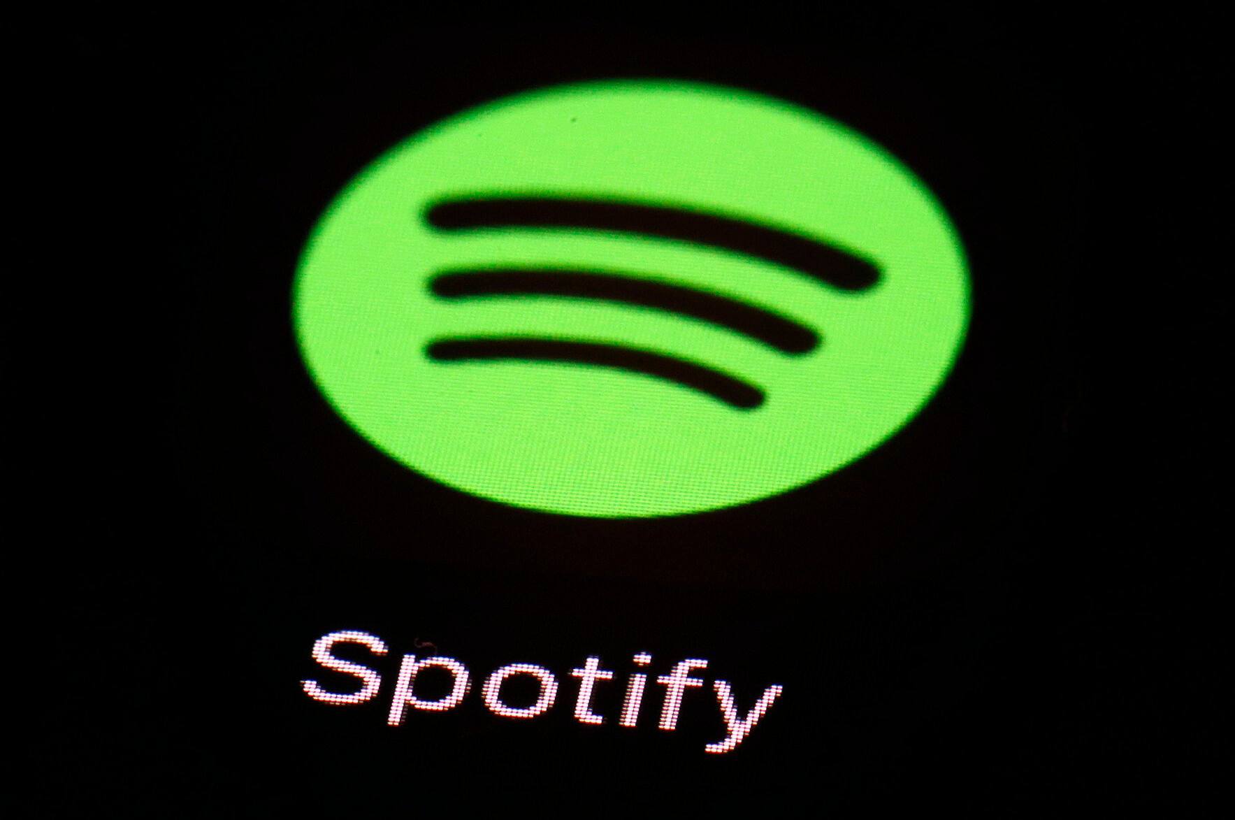 FILE- This March 20, 2018, file photo shows the Spotify app on an iPad in Baltimore. Spotify’s chief financial officer, Paul Vogel, is leaving next year, the music streaming service said, Friday, Dec. 8, 2023, — just days after the company announced its third round of layoffs for 2023. (AP Photo/Patrick Semansky, File)    PHOTO CREDIT: Associated Press