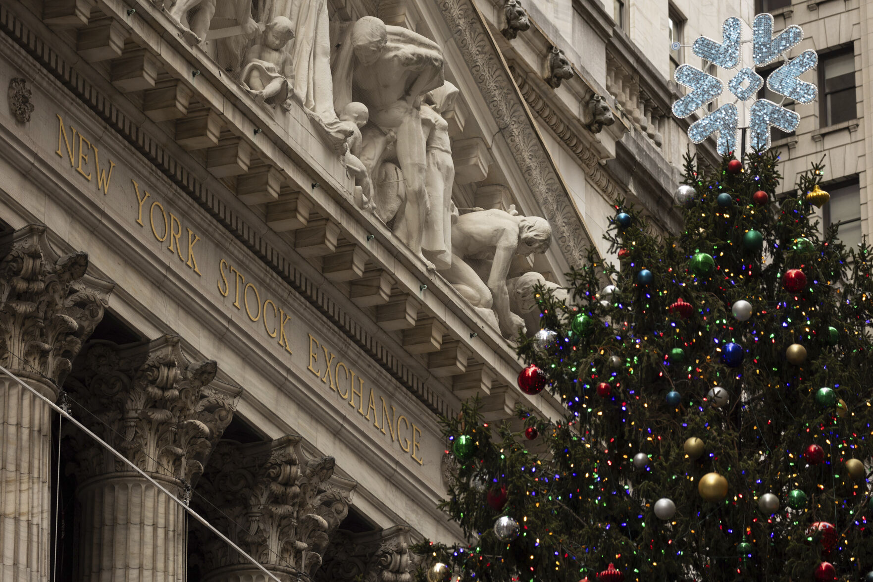A Christmas tree stands in front of the New York Stock Exchange, Monday, Dec. 11, 2023, in New York. World shares advanced Monday ahead of an update on U.S. consumer prices. (AP Photo/Yuki Iwamura)    PHOTO CREDIT: Associated Press
