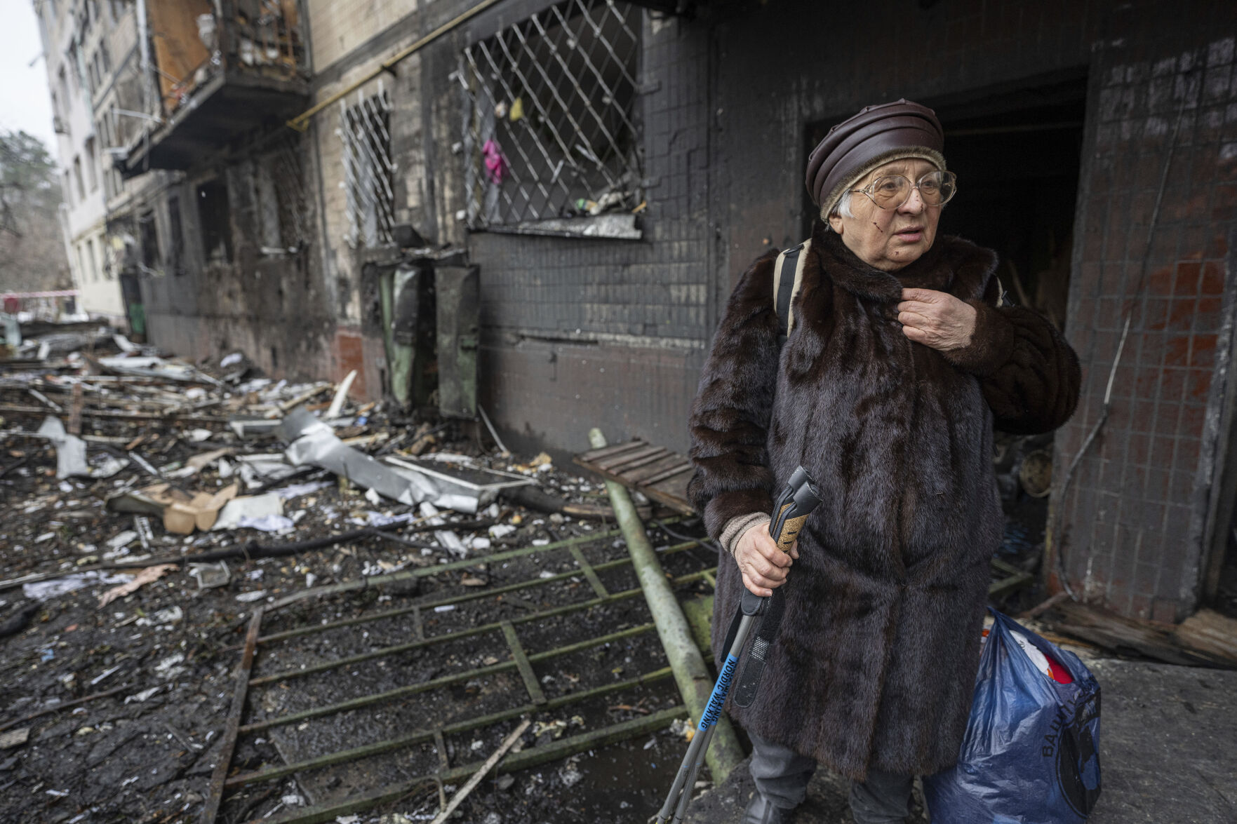 <p>Svitlana Magdenko, 79, stands in front of her damaged house after a Russian rocket attack at a residential neighbourhood in Kyiv, Ukraine, Wednesday, Dec. 13, 2023. (AP Photo/Evgeniy Maloletka)</p>   PHOTO CREDIT: Evgeniy Maloletka 