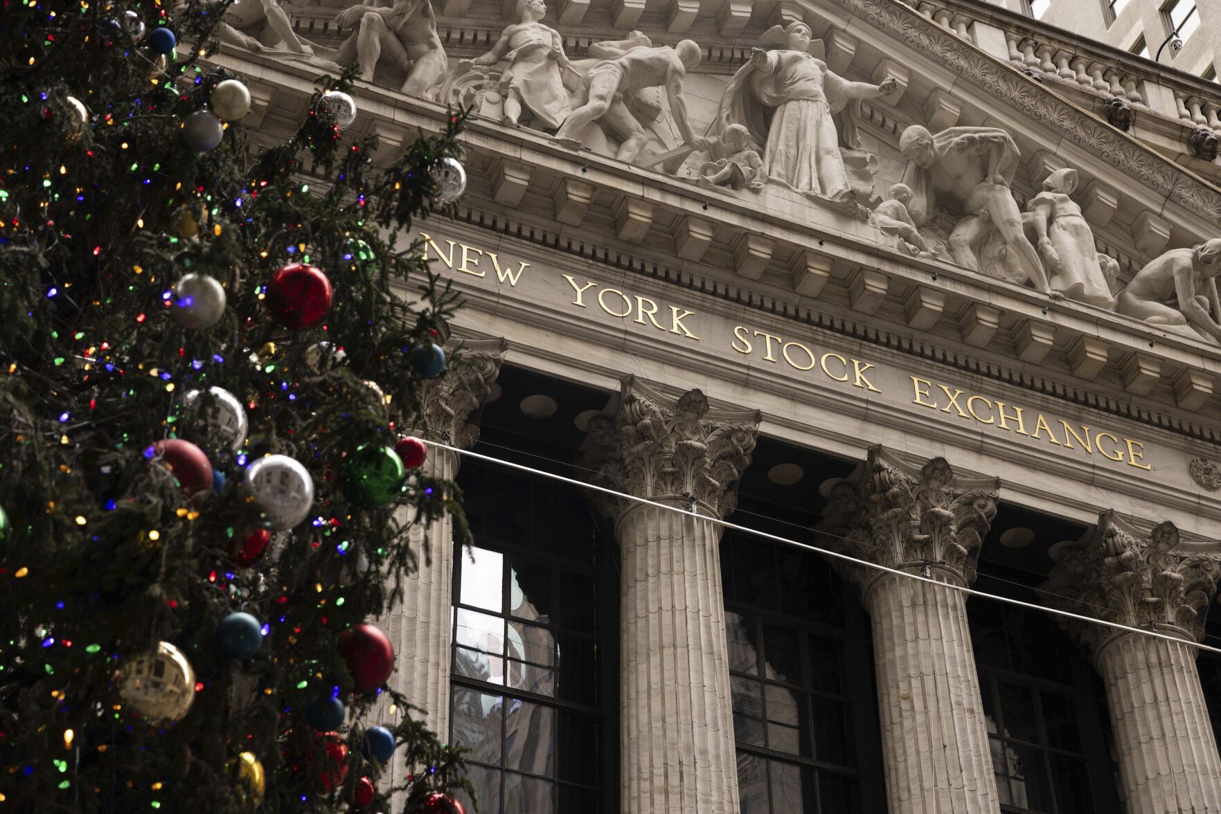 A Christmas tree stands in front of the New York Stock Exchange, Monday, Dec. 11, 2023, in New York. Wall Street is inching up modestly Wednesday ahead of a decision by the U.S. Federal Reserve on interest rates. (AP Photo/Yuki Iwamura)    PHOTO CREDIT: Associated Press