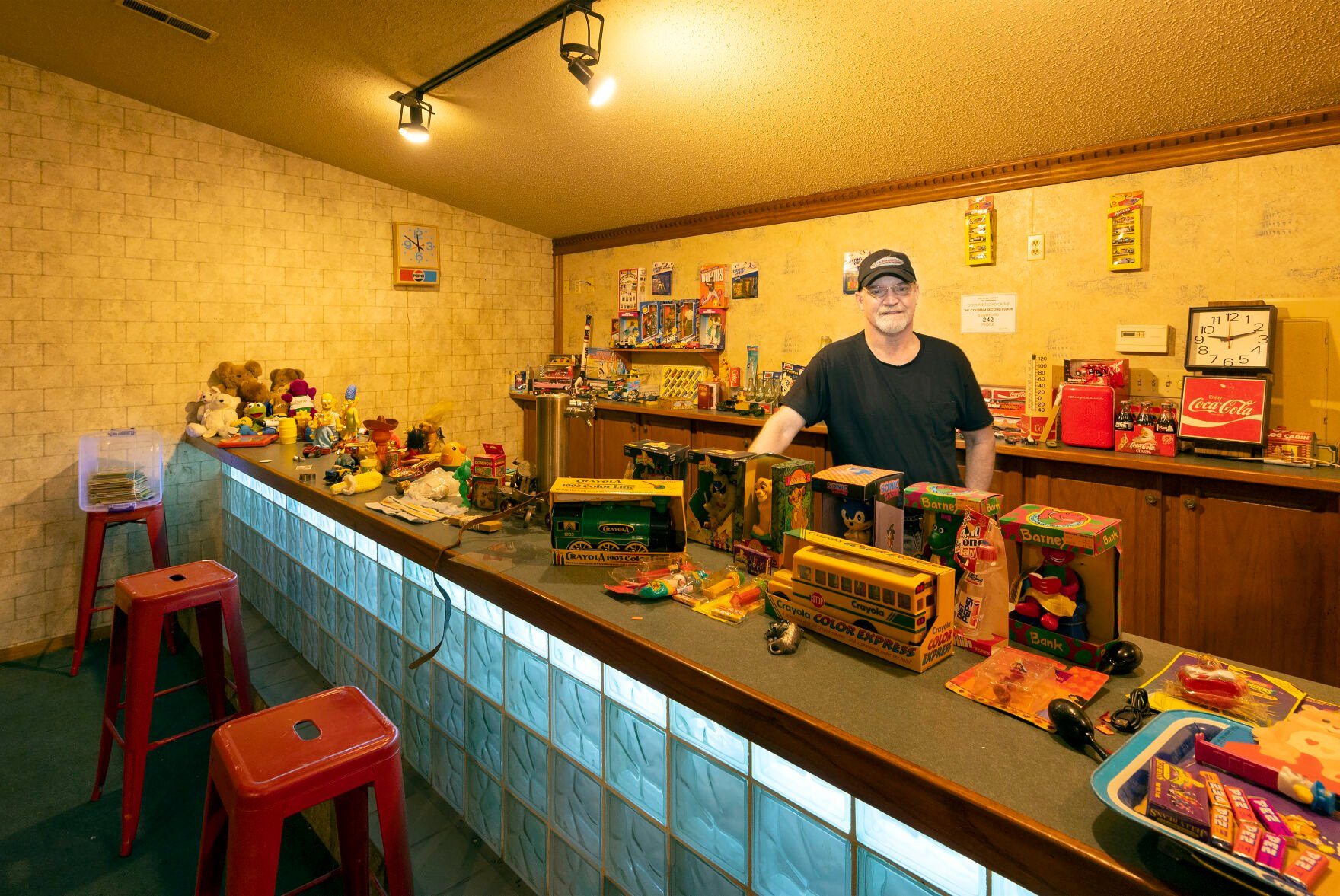 Illinois Treasure Co. co-owner Paul Knupp stands among vintage toys displayed at the store in East Dubuque, Ill., on Monday.    PHOTO CREDIT: Stephen Gassman