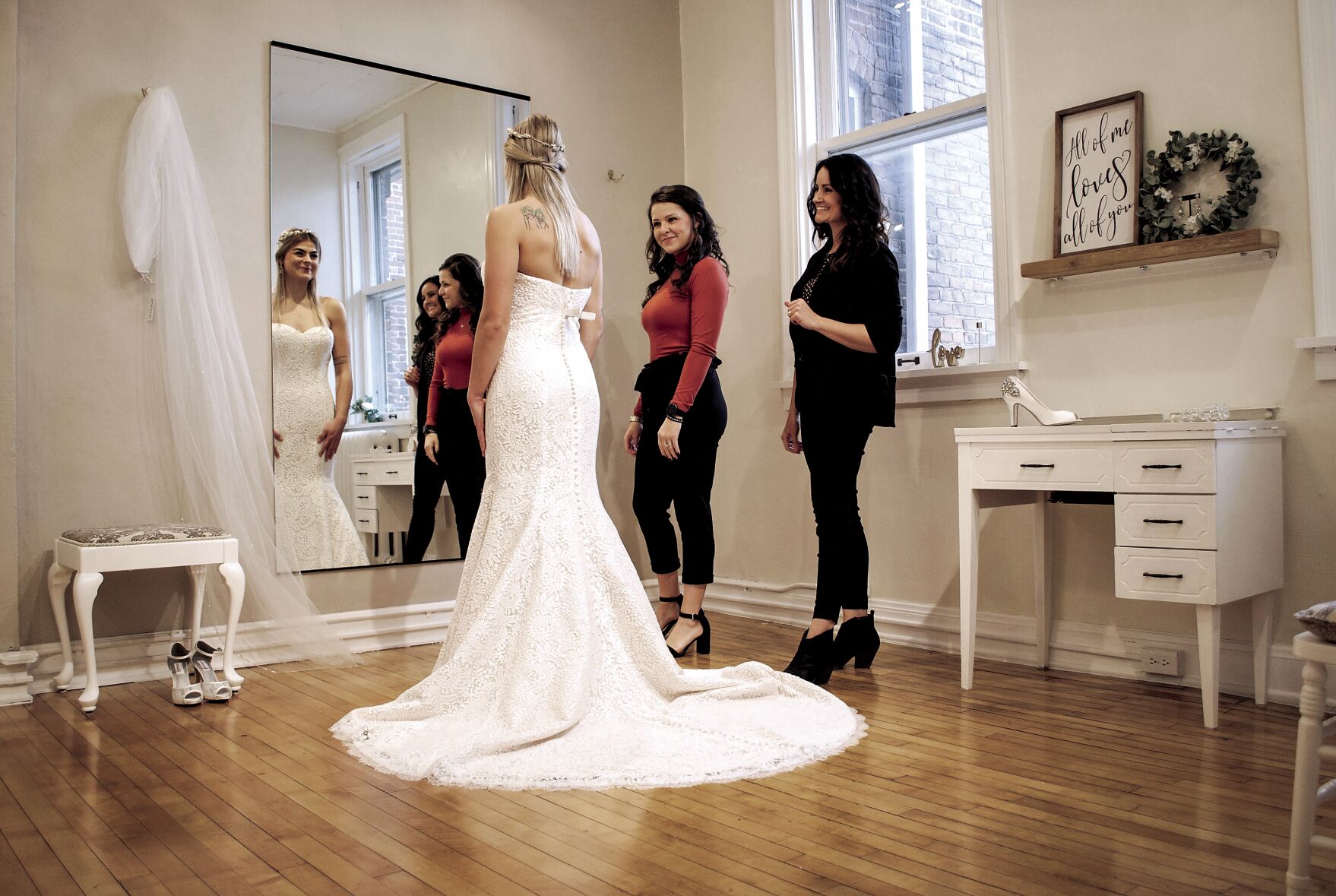 Co-owners Tomi Gill (right) and Hayley Mokros (center) help a bride-to-be at Bridal Boutique, 40 E. Main St. in Platteville, Wis. The store is celebrating 50 years in business.    PHOTO CREDIT: Contributed