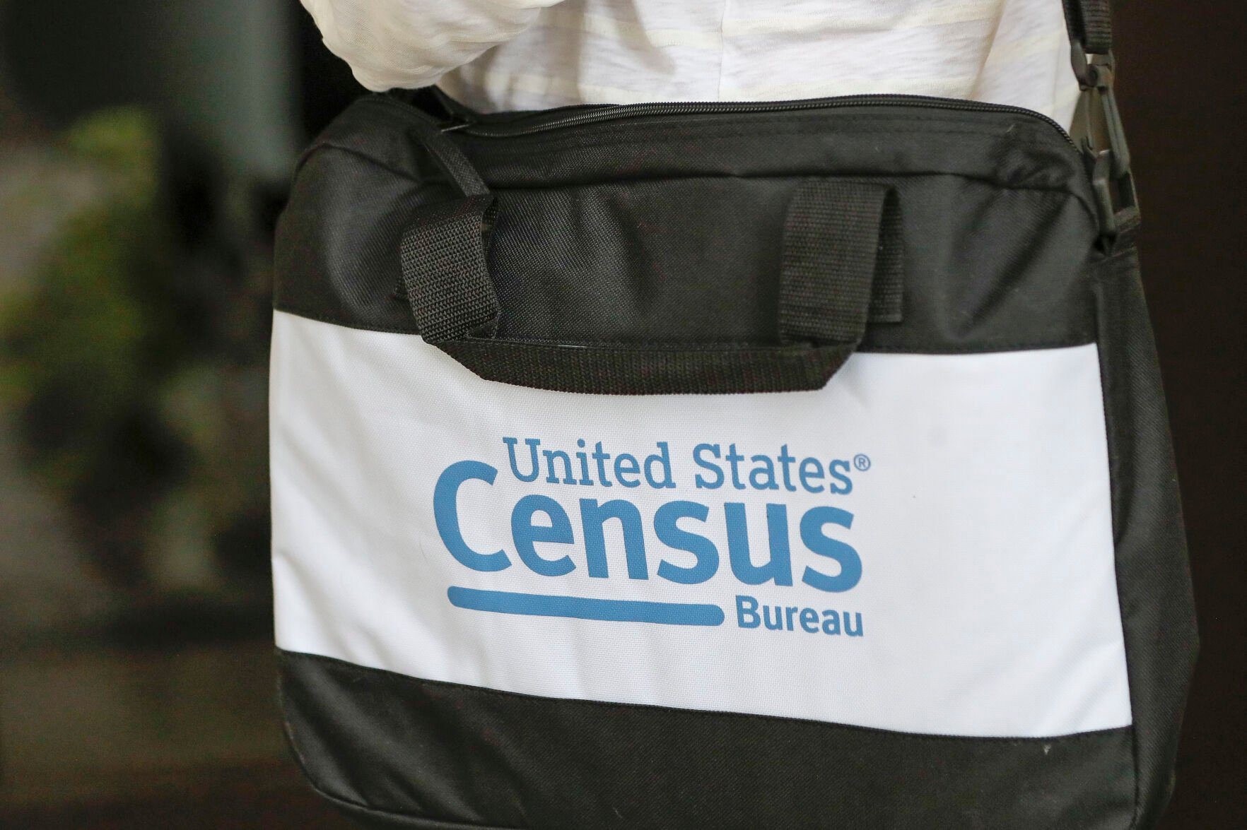 <p>FILE - The briefcase of a census taker is seen as she knocks on the door of a residence, Aug. 11, 2020, in Winter Park, Fla. Eleven small cities in Illinois and Iowa are the only municipalities so far to have signed agreements with the U.S. Census Bureau for a second count of their residents in 2024, the first year the special censuses can be conducted, in a repeat of what happened during the 2020 census. (AP Photo/John Raoux, File)</p>   PHOTO CREDIT: John Raoux