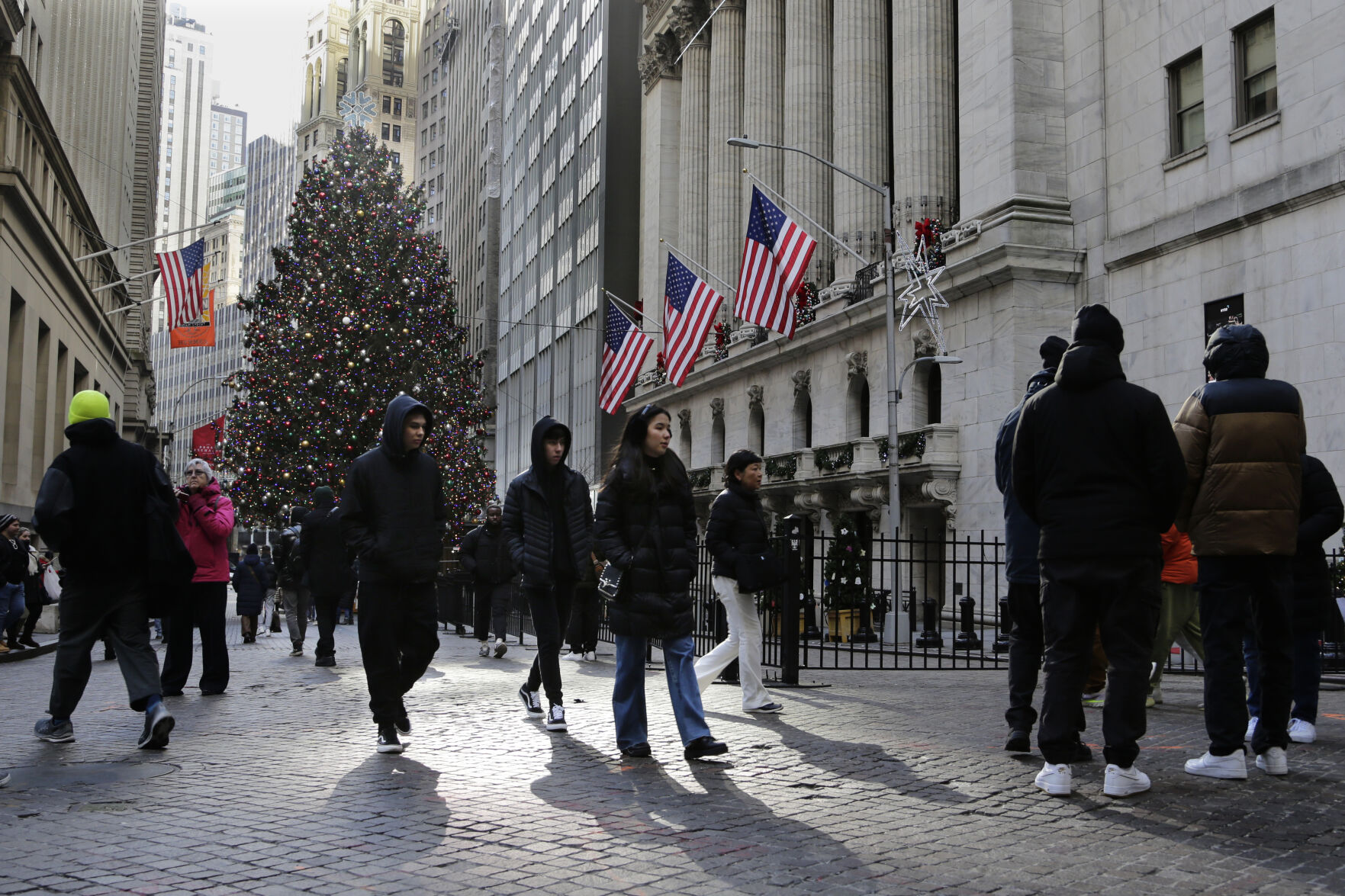 <p>Pedestrians pass the New York Stock Exchange on Tuesday, Jan. 2, 2024 in New York. The S&P 500 was lower in midday trading after pulling to the brink of its all-time high set roughly two years ago. (AP Photo/Peter Morgan)</p>   PHOTO CREDIT: Peter Morgan 