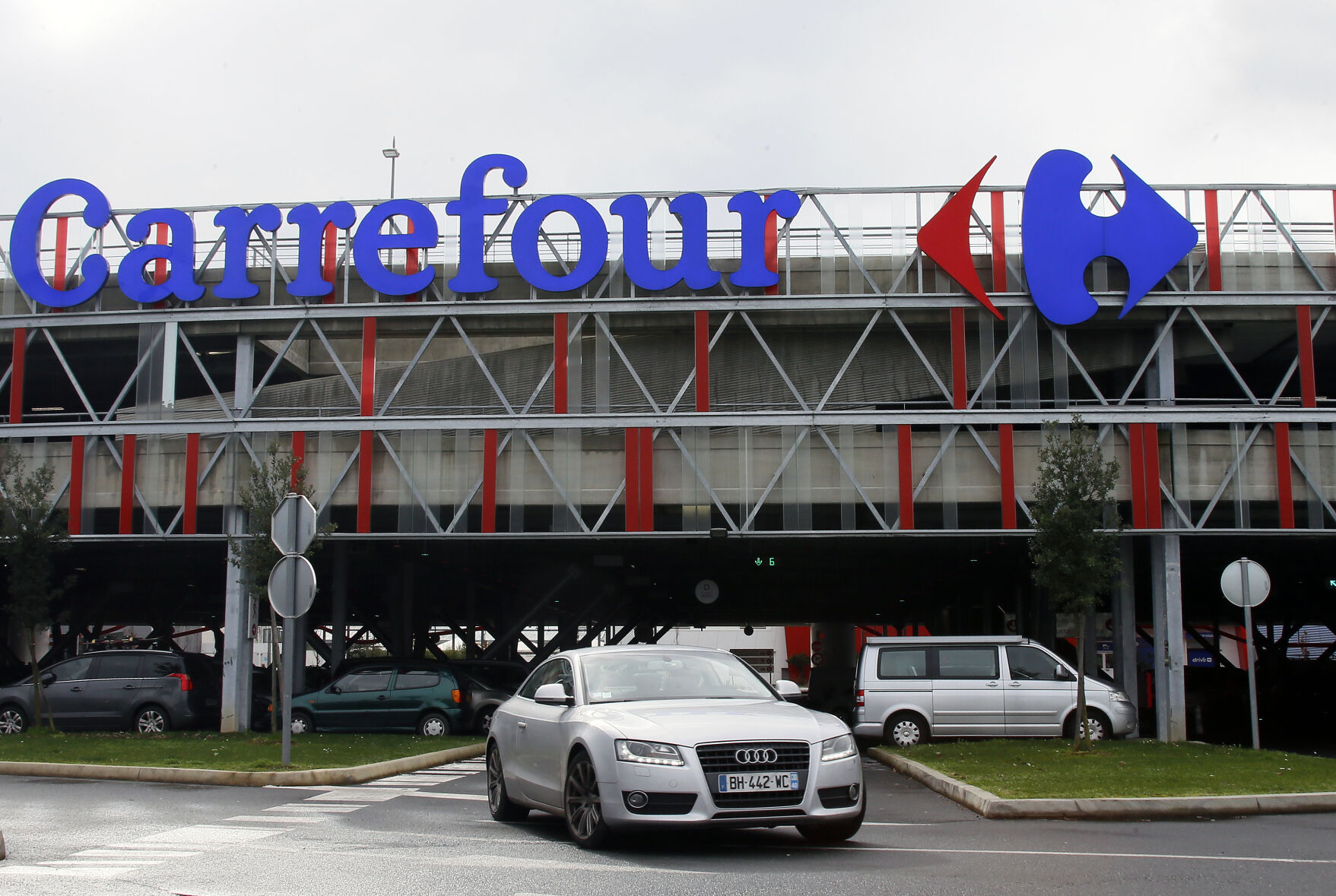 FILE - Car leaves a Carrefour supermarket in Anglet, southwestern France, on Jan.23, 2018. Global supermarket chain Carrefour will stop selling PepsiCo products in its stores in France, Belgium, Spain and Italy over price increases for popular items like Lay