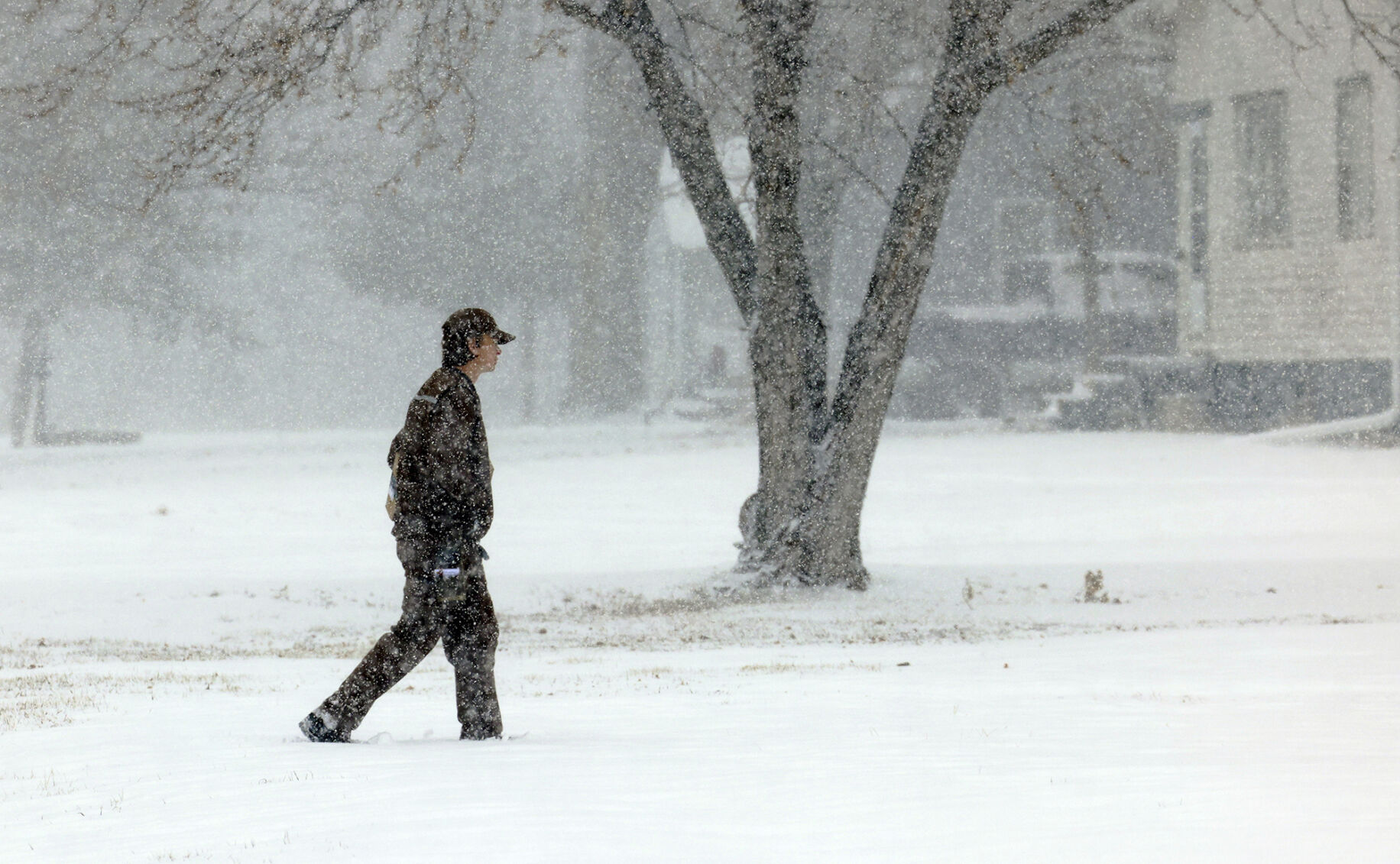 <p>A UPS employee delivers a package in the snow Monday, Jan. 8, 2024, in Palmer, Neb. (Josh Salmon/The Independent via AP)</p>   PHOTO CREDIT: Josh Salmon 