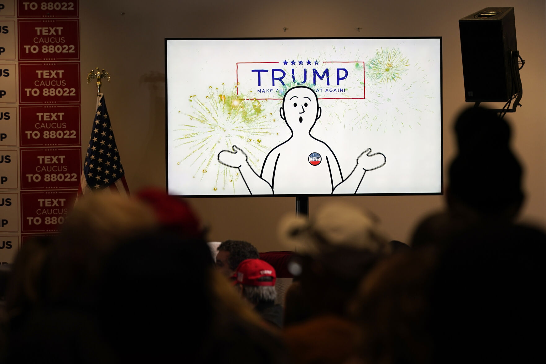 <p>A video plays before former President Donald Trump speaks at a rally at Terrace View Event Center in Sioux Center, Iowa, Friday, Jan. 5, 2024. Well before Trump takes the stage, a waiting audience of hundreds of supporters sits captivated as dramatic music begins to swell throughout the room. On projector screens, a rotating Planet Earth appears. “Making America Great Again starts one place on Earth, and one place only,” a deep-voiced narrator begins as the image zooms into the middle of the U.S. “Right here in Iowa.”(AP Photo/Andrew Harnik)</p>   PHOTO CREDIT: Andrew Harnik 