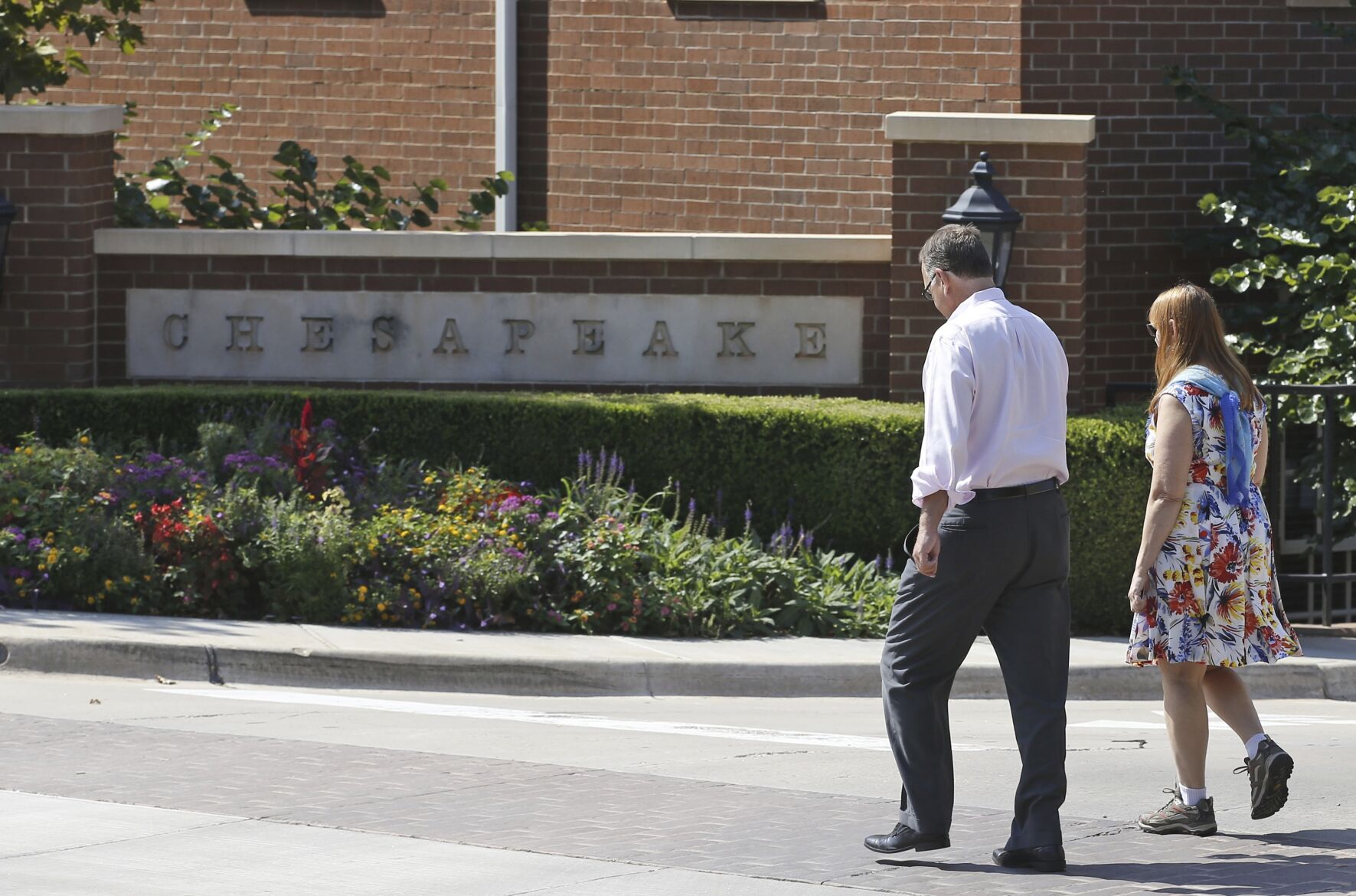 <p>FILE - Two people walk past one of the entrances to the Chesapeake Energy Corporation campus in Oklahoma City, Tuesday, Sept. 29, 2015. Chesapeake Energy and Southwestern Energy are combining in a $7.4 billion all-stock deal, Thursday, Jan. 11, 2024 to form one of the biggest natural gas producers in the U.S. (AP Photo/Sue Ogrocki, File)</p>   PHOTO CREDIT: Sue Ogrocki