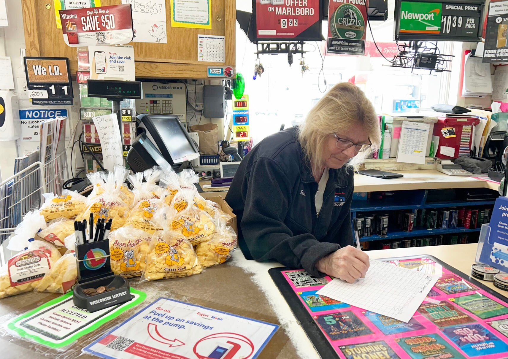 Employee Monica Fritz fills out paperwork. Fritz is one of four employees at the convenience store and has worked at the business for 10 years.    PHOTO CREDIT: Erik Hogstrom
Telegraph Herald