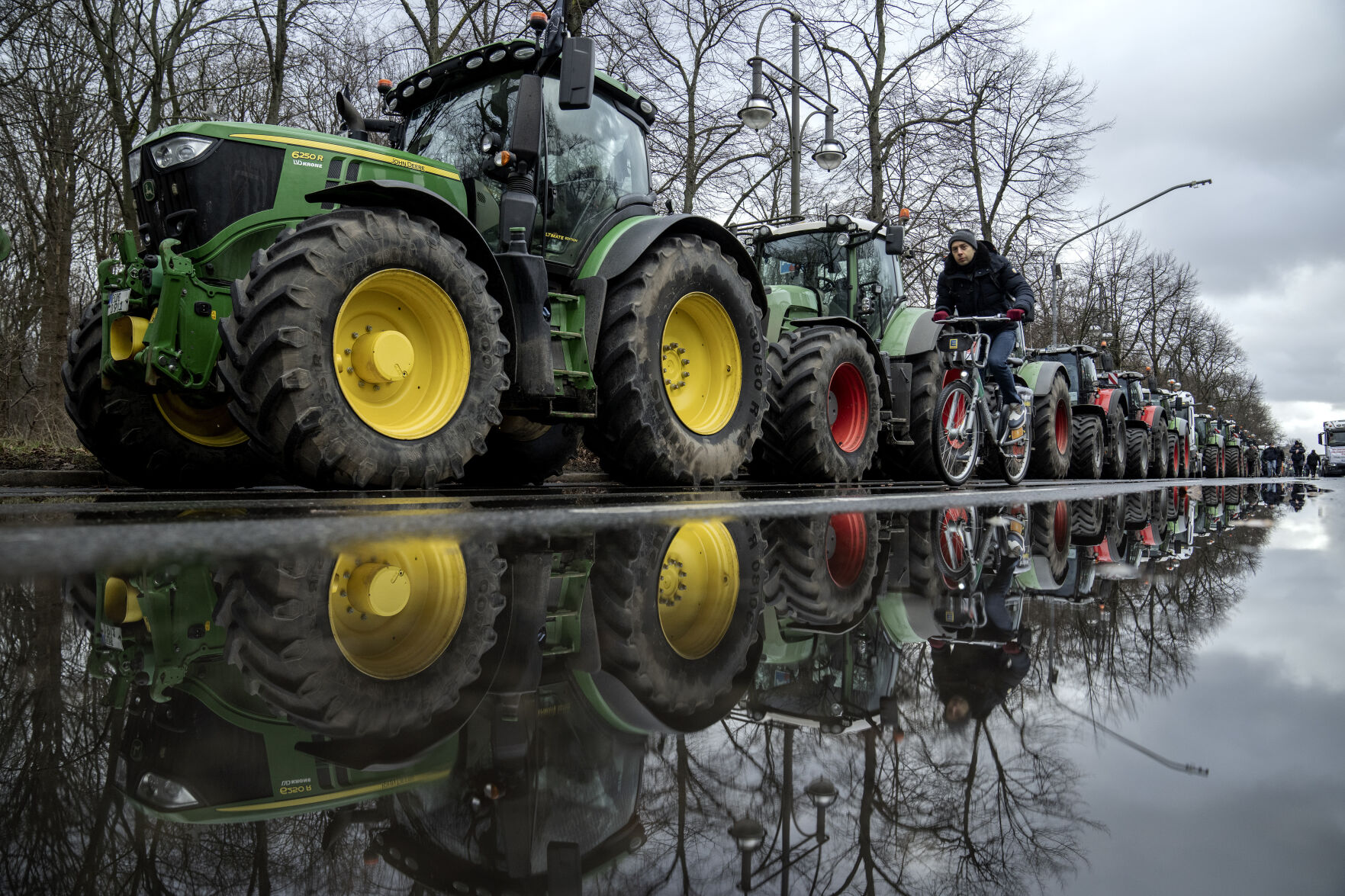 Farmers place their tractors at the government district in Berlin, Germany, Monday, Jan. 15, 2024 ahead of a demonstration. Farmers drove thousands of tractors into Berlin on Monday in the climax of a week of demonstrations against a plan to scrap tax breaks on the diesel they use, a protest that has tapped into wider discontent with Germany’s government. (AP Photo/Ebrahim Noroozi)    PHOTO CREDIT: Associated Press