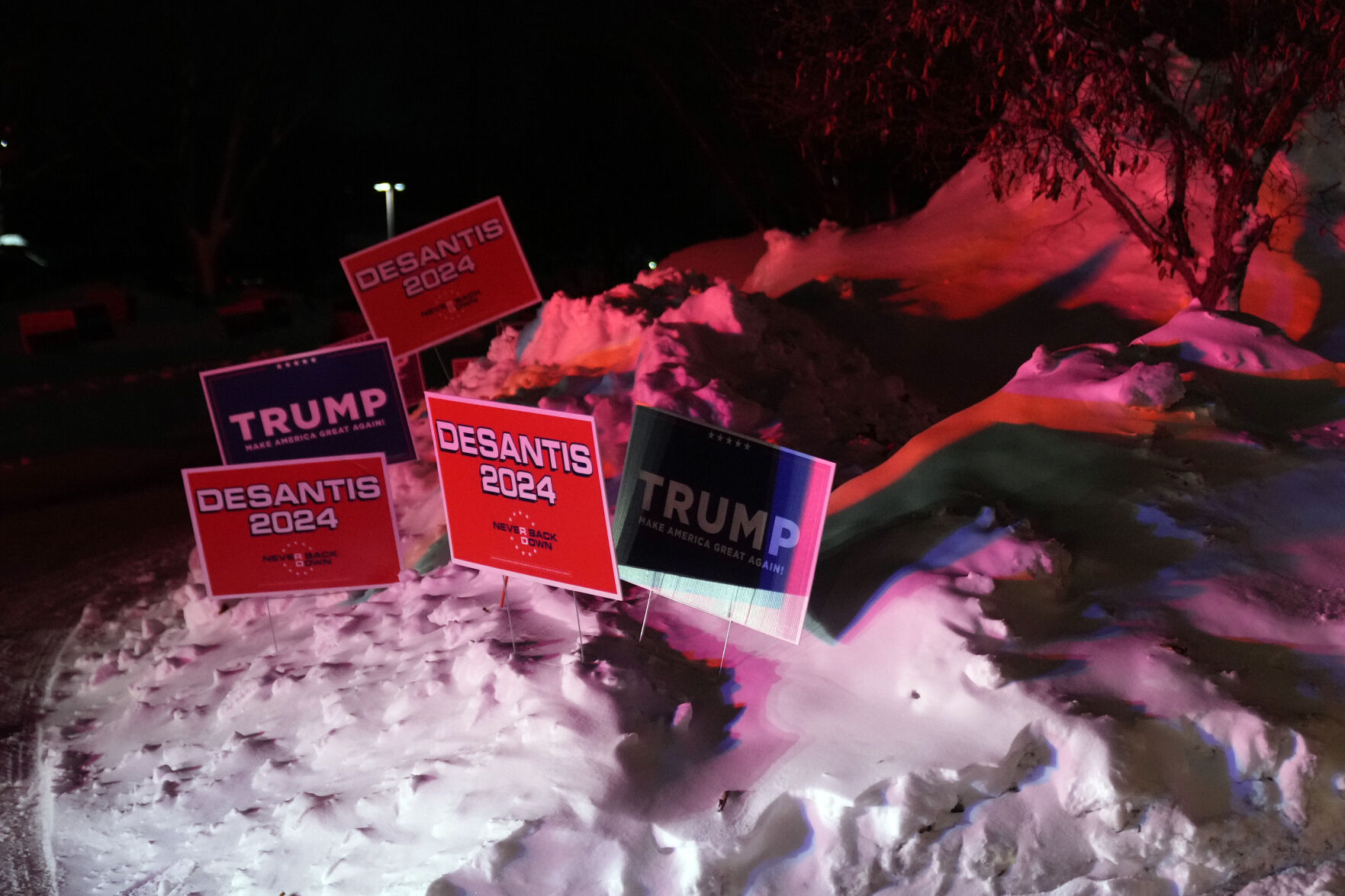 <p>Campaign signs are placed in a snow bank outside a caucus site at Horizon Events Center, in Clive, Iowa, Monday, Jan. 15, 2024. (AP Photo/Andrew Harnik)</p>   PHOTO CREDIT: Andrew Harnik 