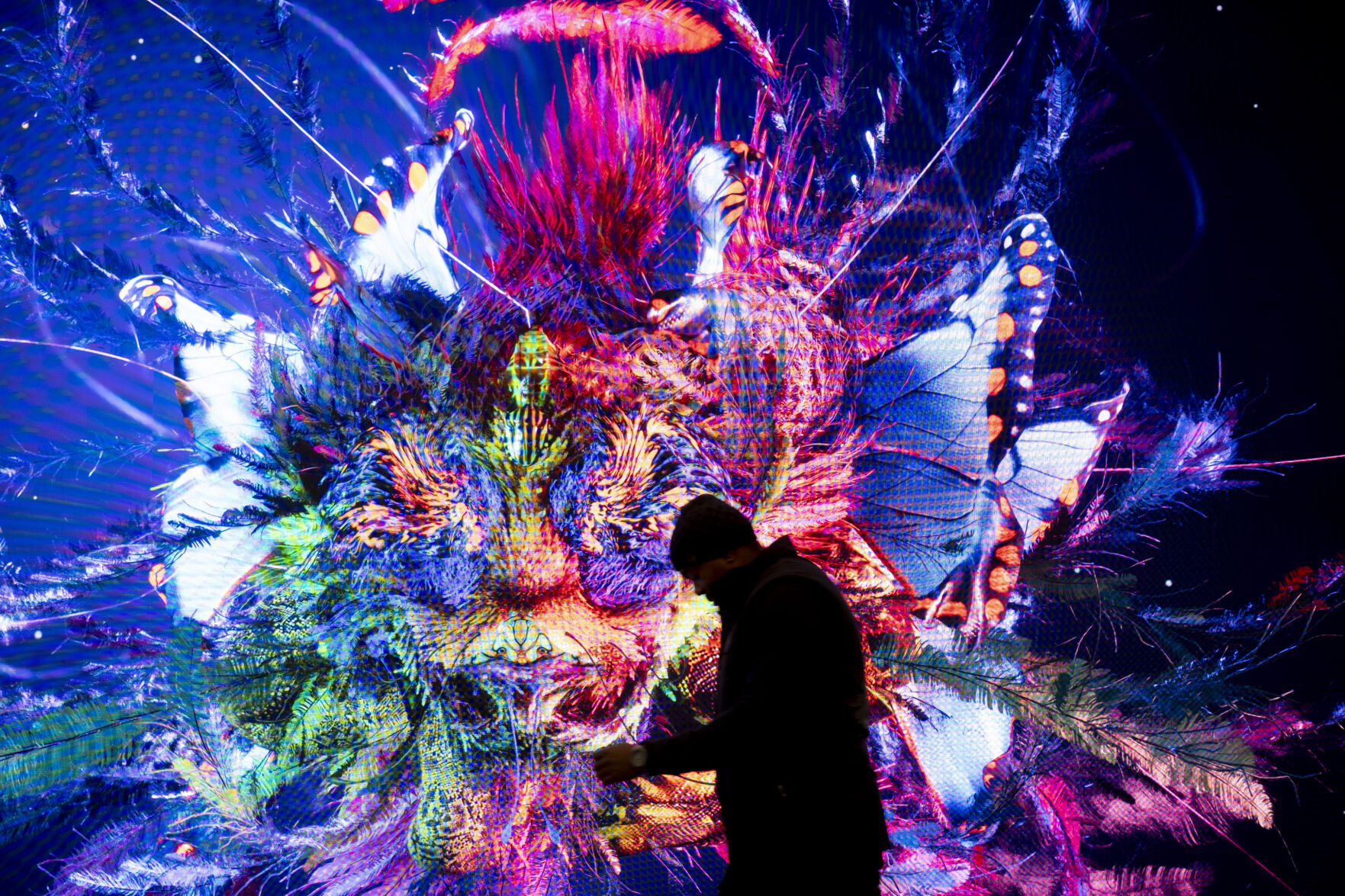 <p>A man walks in front of a screen with a artificial intelligence generated artwork by media artist Refik Anadol, inside the Congress Center where the World Economic Forum take place in Davos, Switzerland, Sunday, Jan. 14, 2024. The annual meeting of the World Economic Forum is taking place in Davos from Jan. 15 until Jan. 19, 2024. (AP Photo/Markus Schreiber)</p>   PHOTO CREDIT: Markus Schreiber 