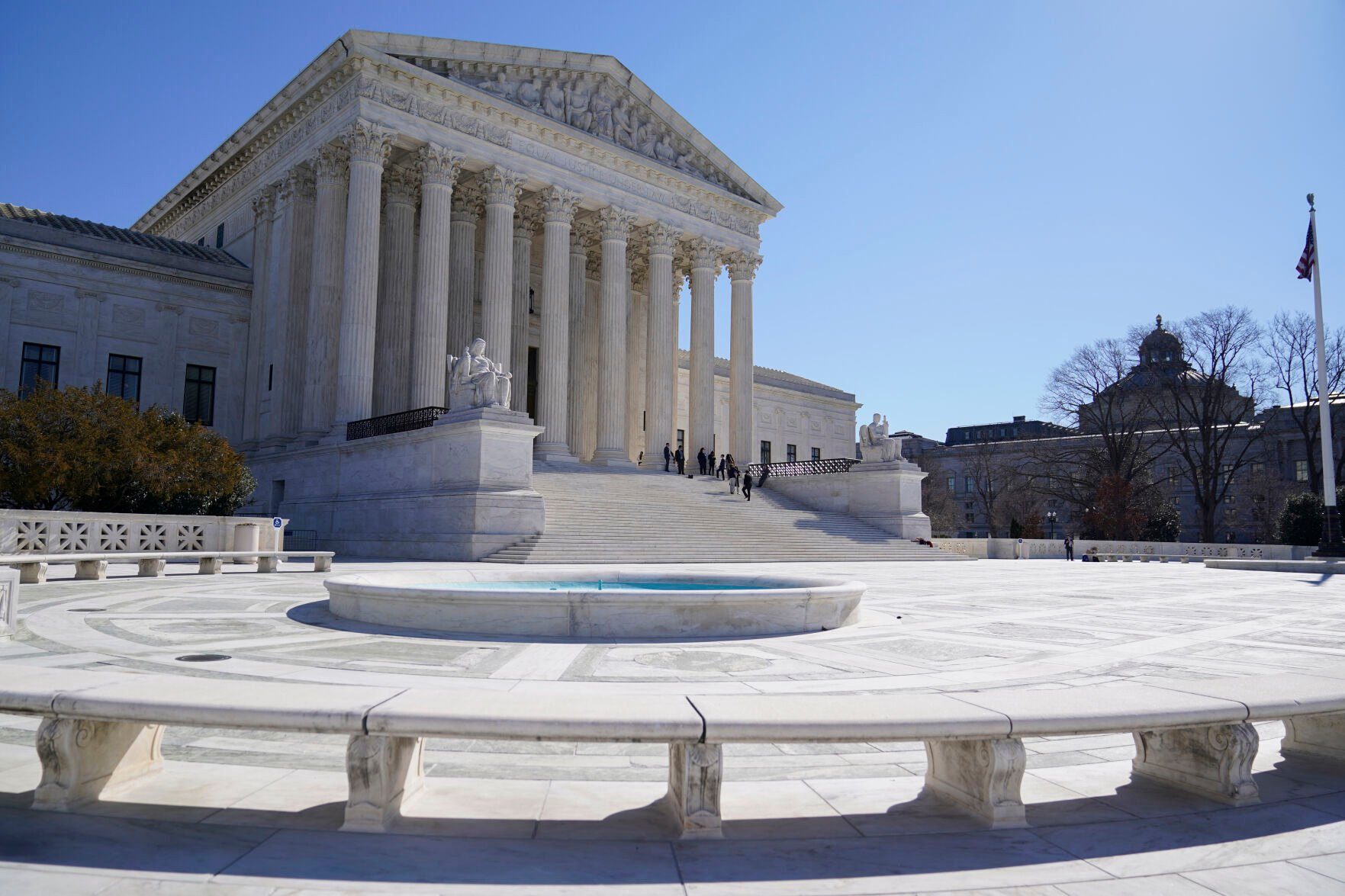 <p>FILE - People stand on the steps of the U.S. Supreme Court, Feb.11, 2022, in Washington. The Supreme Court is taking up challenges by commercial fishermen to a fee requirement that could achieve a long-sought goal of business and conservative interests, limiting a wide range of government regulations. Billions of dollars are potentially at stake. (AP Photo/Mariam Zuhaib, File)</p>   PHOTO CREDIT: Mariam Zuhaib