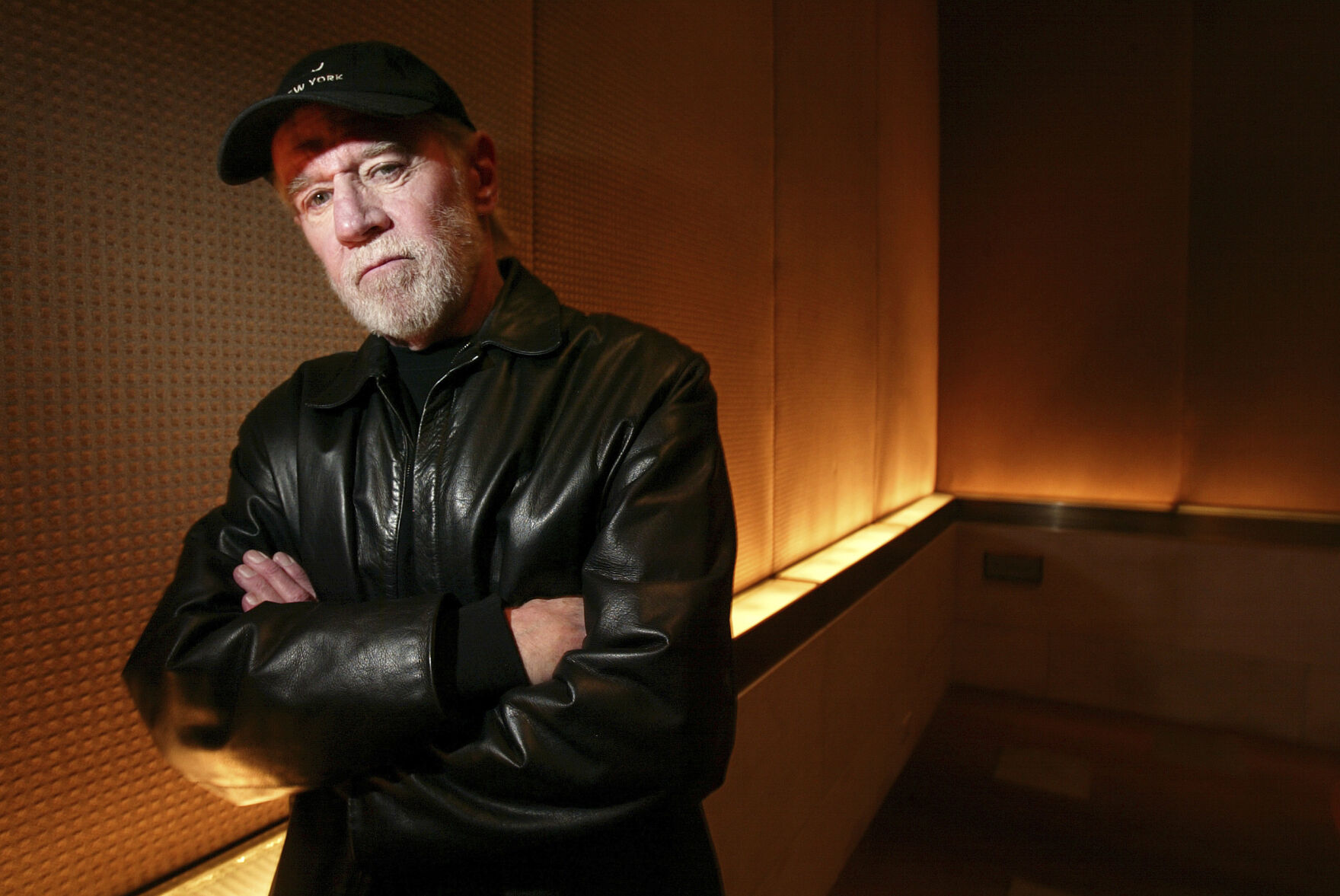 FILE - Actor and comedian George Carlin poses in a New York hotel March 19, 2004. Carlin