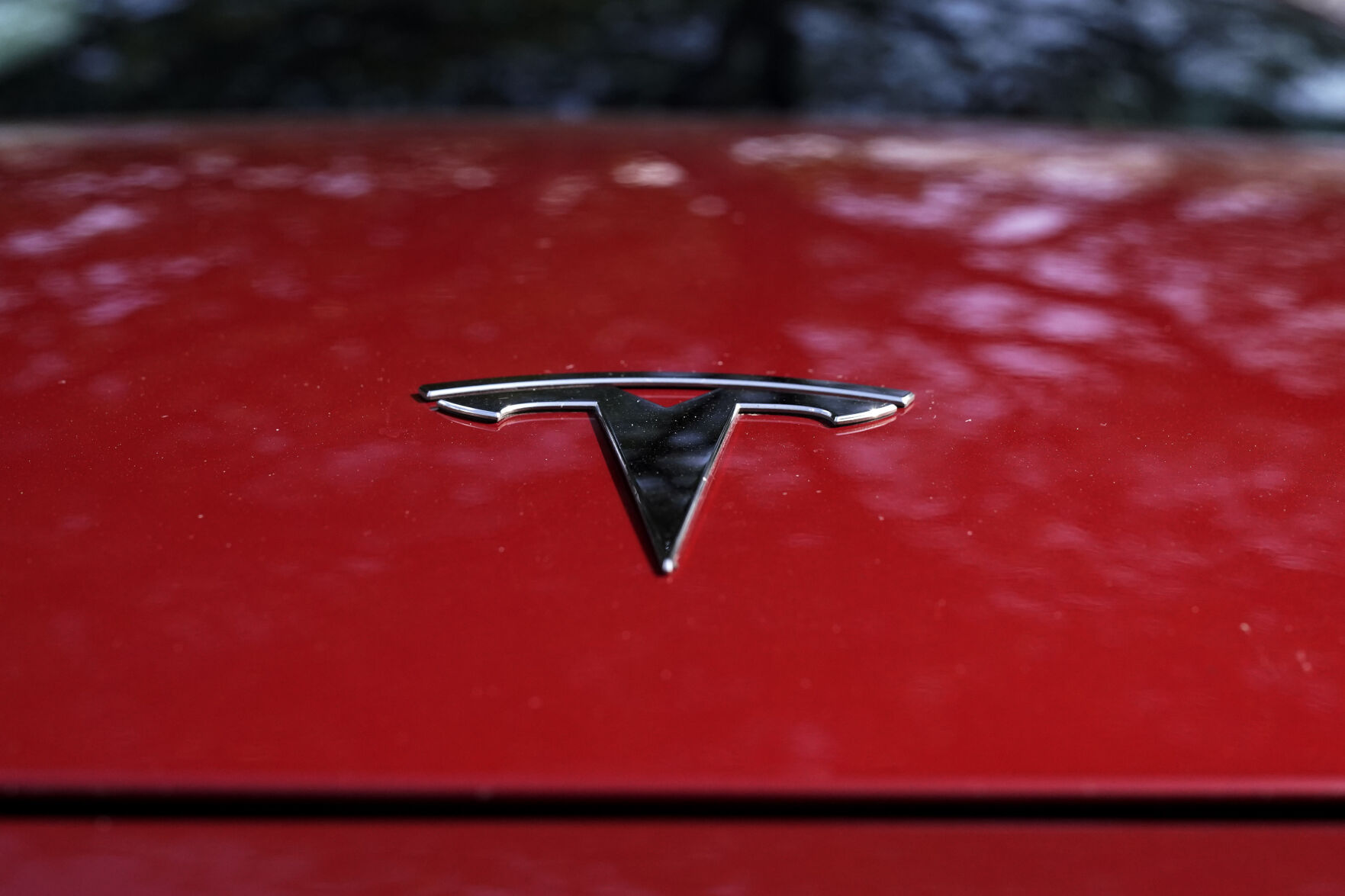 FILE - A Tesla logo is seen on a vehicle on display in Austin, Texas, Feb. 22, 2023. Shares of Tesla tumbled at the opening bell Thursday, Jan. 25, 2024 as the electric vehicle, solar panel and battery maker warned investors of slower sales growth in 2024 after putting up quarterly financial results that were weaker than most had expected. (AP Photo/Eric Gay, File)    PHOTO CREDIT: Associated Press