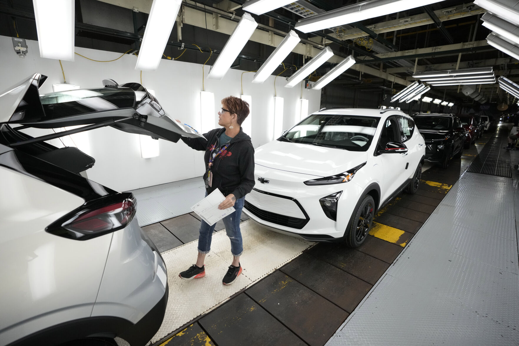 <p>File - Assembly line worker Janice DeBono looks over a 2023 Chevrolet Bolt EUV at the General Motors Orion Assembly, June 15, 2023, in Lake Orion, Mich. General Motors reports earnings on Jan. 30, 2024. (AP Photo/Carlos Osorio, File)</p>   PHOTO CREDIT: Carlos Osorio 
