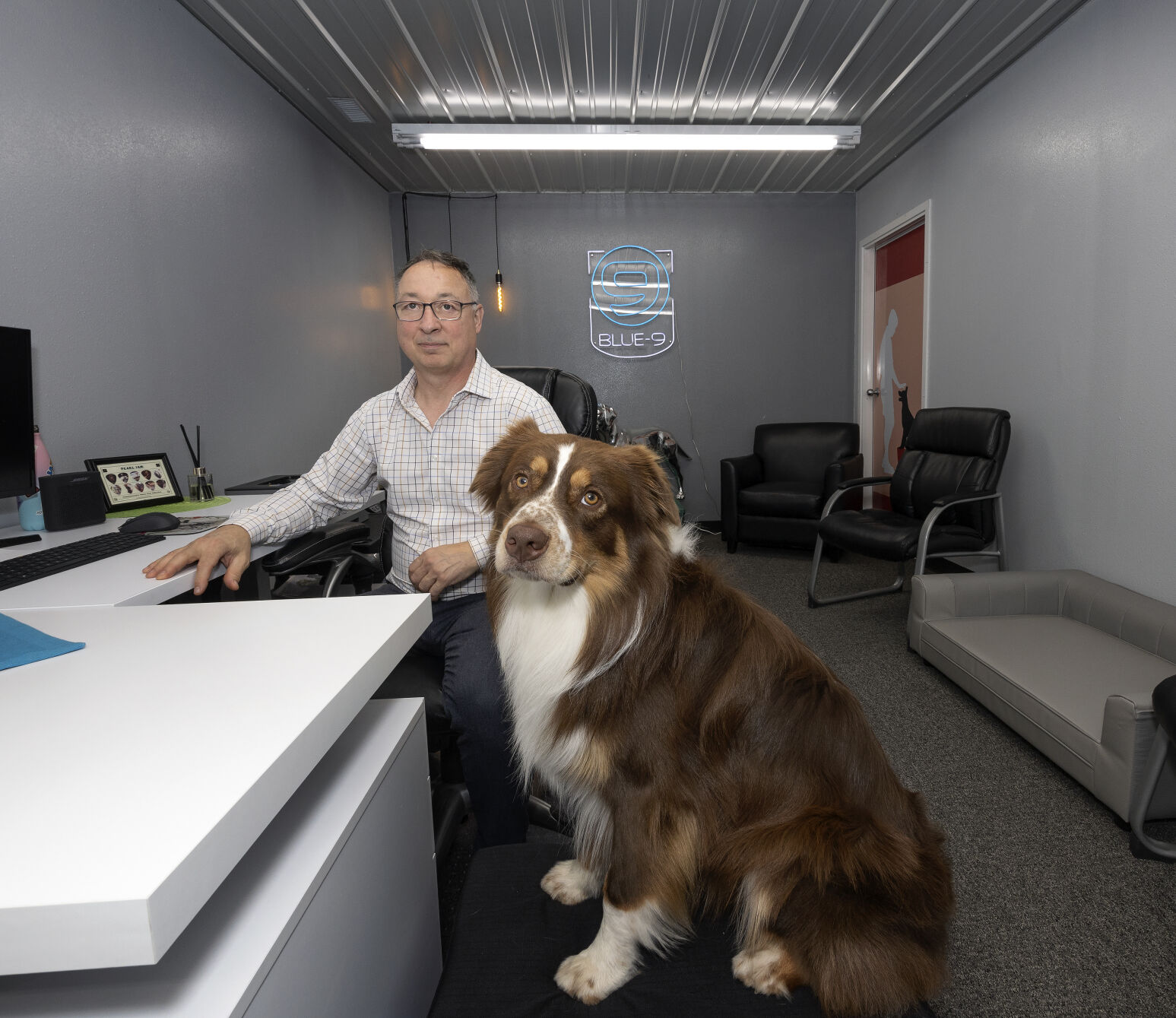 Blue-9 CEO David Blake and his dog, Cork, in the company’s lobby in Maquoketa, Iowa.    PHOTO CREDIT: Stephen Gassman
Telegraph Herald