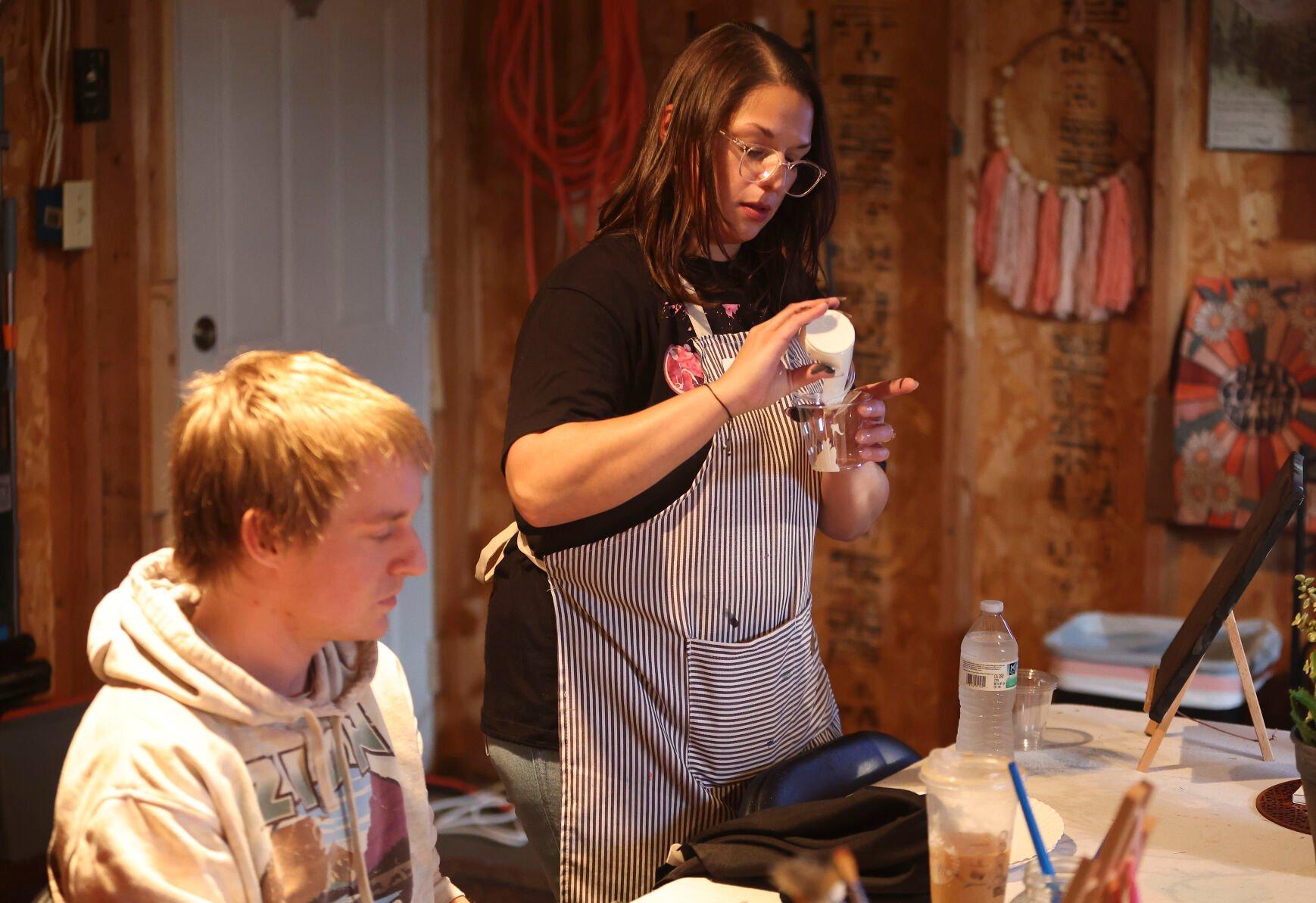 Owner of The Stoned Painter, Maria Cigrand, supplies paint to her students during a class held in East Dubuque, Ill.    PHOTO CREDIT: Dave Kettering
Telegraph Herald