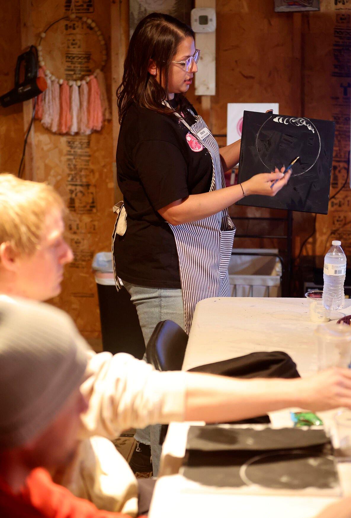 Owner of The Stoned Painter, Maria Cigrand, demonstrates to her students during a class held in East Dubuque, Ill.    PHOTO CREDIT: Dave Kettering
Telegraph Herald
