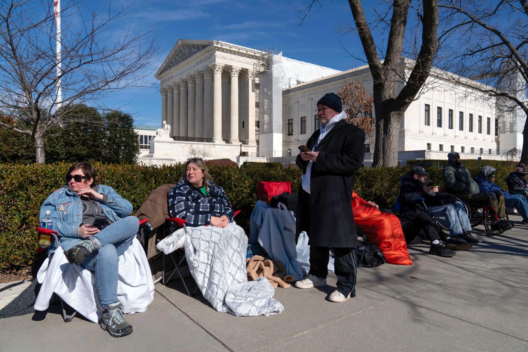 <p>People wait in line outside of the U.S. Supreme Court to have a place in the upcoming hearing on whether former President Donald Trump is ineligible for the 2024 ballot, Wednesday, Feb. 7, 2024, in Washington. (AP Photo/Jose Luis Magana)</p>   PHOTO CREDIT: Jose Luis Magana
