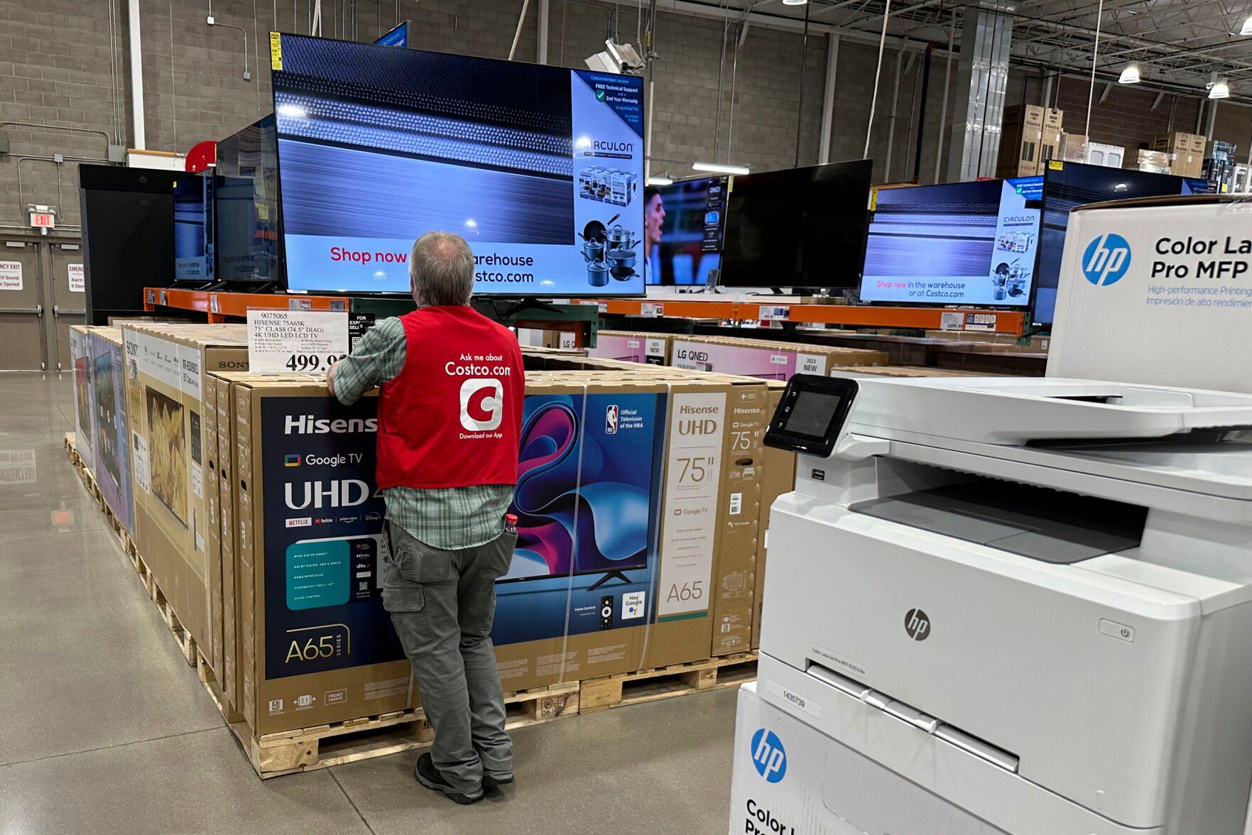 <p>An associate checks over a big-screen television on display in a Costco warehouse Tuesday, Feb. 6, 2024, in Colorado Springs, Colo. On Tuesday, The Labor Department issues its report on inflation at the consumer level in January. (AP Photo/David Zalubowski)</p>   PHOTO CREDIT: David Zalubowski 