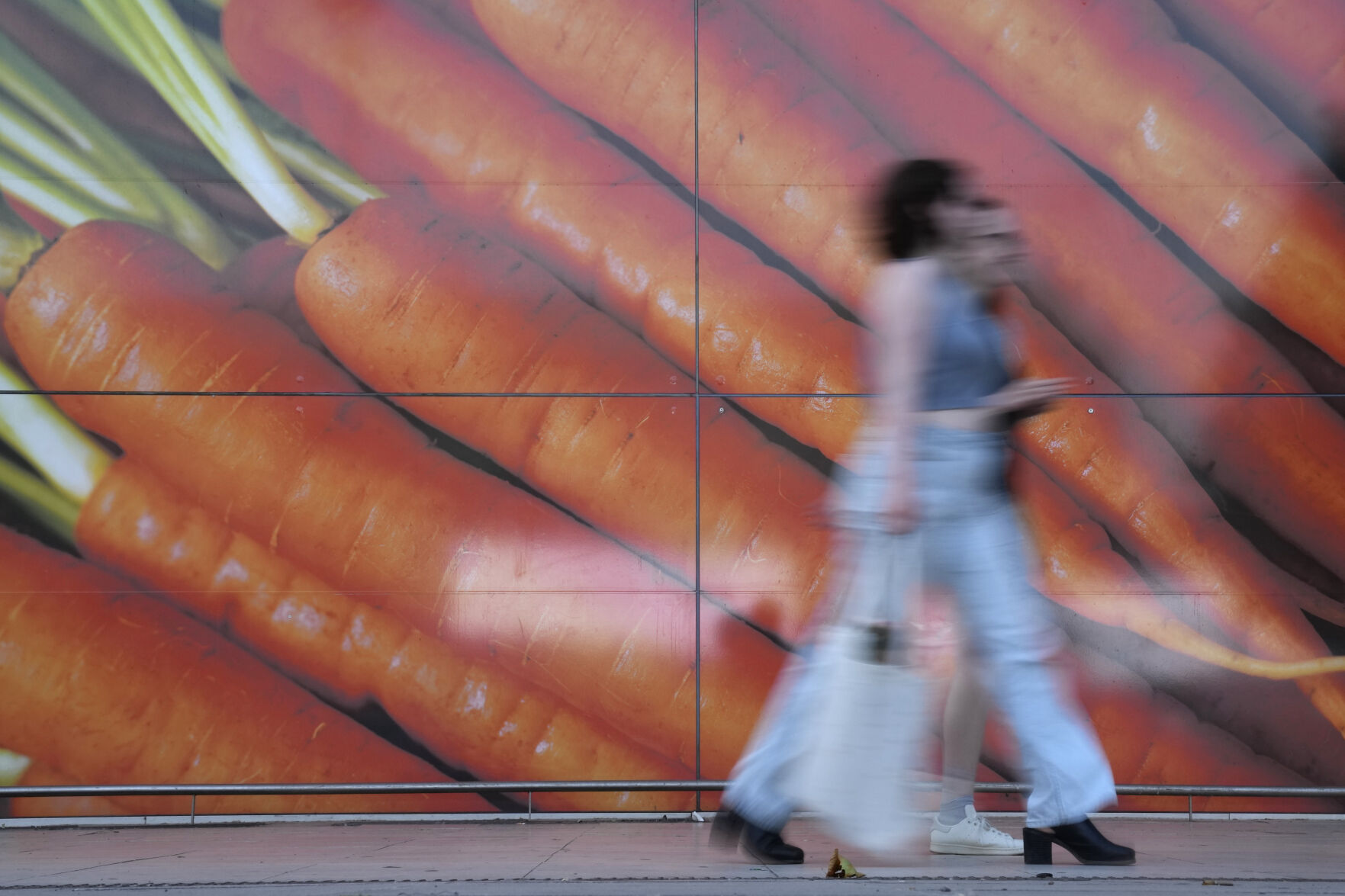 <p>FILE - Shoppers walk past a large poster outside a supermarket in London, on June 10, 2023. Inflation in the U.K. held steady at 4% in January as lower food prices helped offset an increase in energy costs, official figures showed Wednesday, Feb. 14, 2024. The reading was better than expected as most economists expected inflation to rise modestly to around 4.2%. The Office for National Statistics said the monthly drop in food prices of 0.4% was the first since September 2021. (AP Photo/Alastair Grant)</p>   PHOTO CREDIT: Alastair Grant 