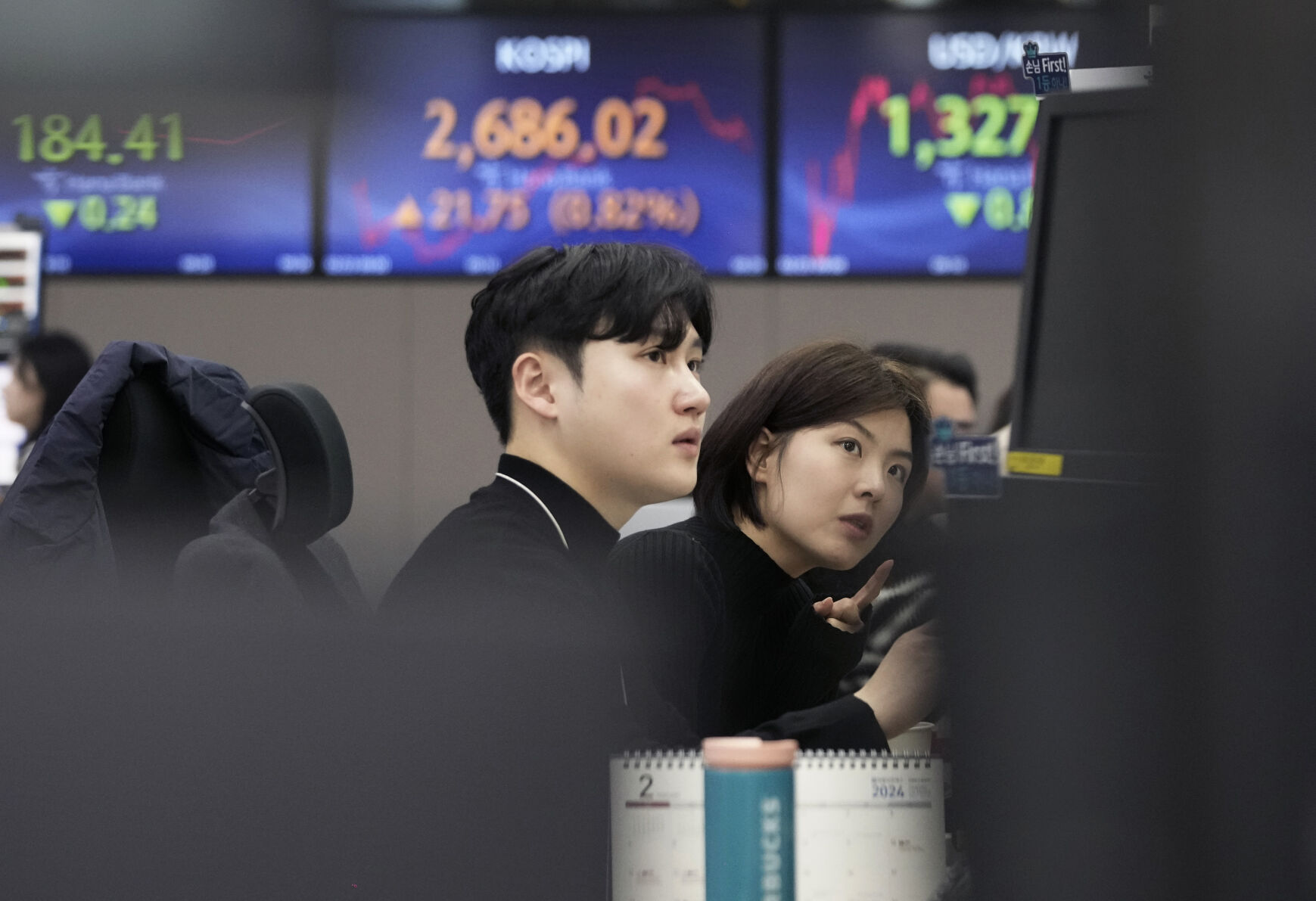 <p>Currency traders watch monitors at the foreign exchange dealing room of the KEB Hana Bank headquarters in Seoul, South Korea, Friday, Feb. 23, 2024. Asian markets mostly gained on Friday after Nvidia delivered another blowout quarter, setting off a rally in other technology companies that carried Wall Street to another record high. (AP Photo/Ahn Young-joon)</p>   PHOTO CREDIT: Ahn Young-joon - staff, ASSOCIATED PRESS
