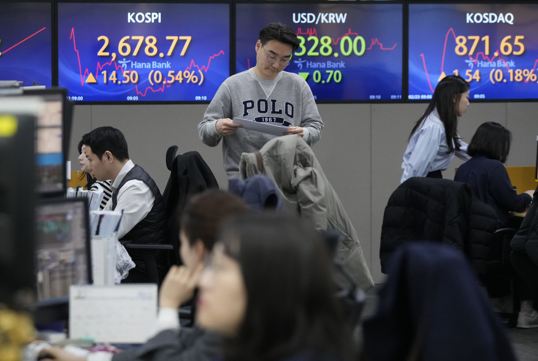 <p>A currency trader passes by the screens showing the Korea Composite Stock Price Index (KOSPI), left, and the foreign exchange rate between U.S. dollar and South Korean won, center, at the foreign exchange dealing room of the KEB Hana Bank headquarters in Seoul, South Korea, Friday, Feb. 23, 2024. Asian markets mostly gained on Friday after Nvidia delivered another blowout quarter, setting off a rally in other technology companies that carried Wall Street to another record high. (AP Photo/Ahn Young-joon)</p>   PHOTO CREDIT: Ahn Young-joon - staff, ASSOCIATED PRESS