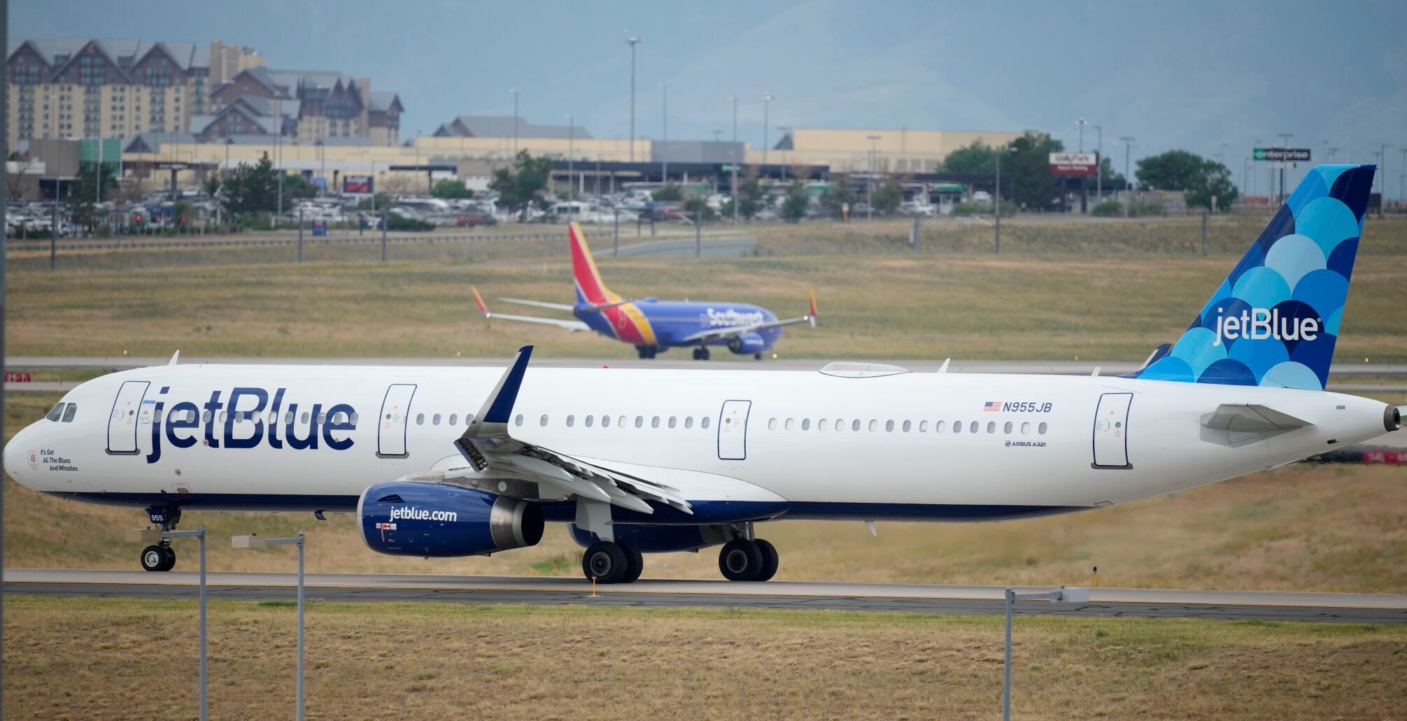 <p>FILE - A Jet Blue jetliner taxis down a runway as a Southwest Airlines airliner takes off from Denver International Airport Tuesday, July 5, 2022, in Denver. Shares of JetBlue are rising more than 15% before the market open on Tuesday, Feb. 13, 2024, as activist investor Carl Icahn took an almost 10% stake in the airline. (AP Photo/David Zalubowski, File)</p>   PHOTO CREDIT: David Zalubowski 