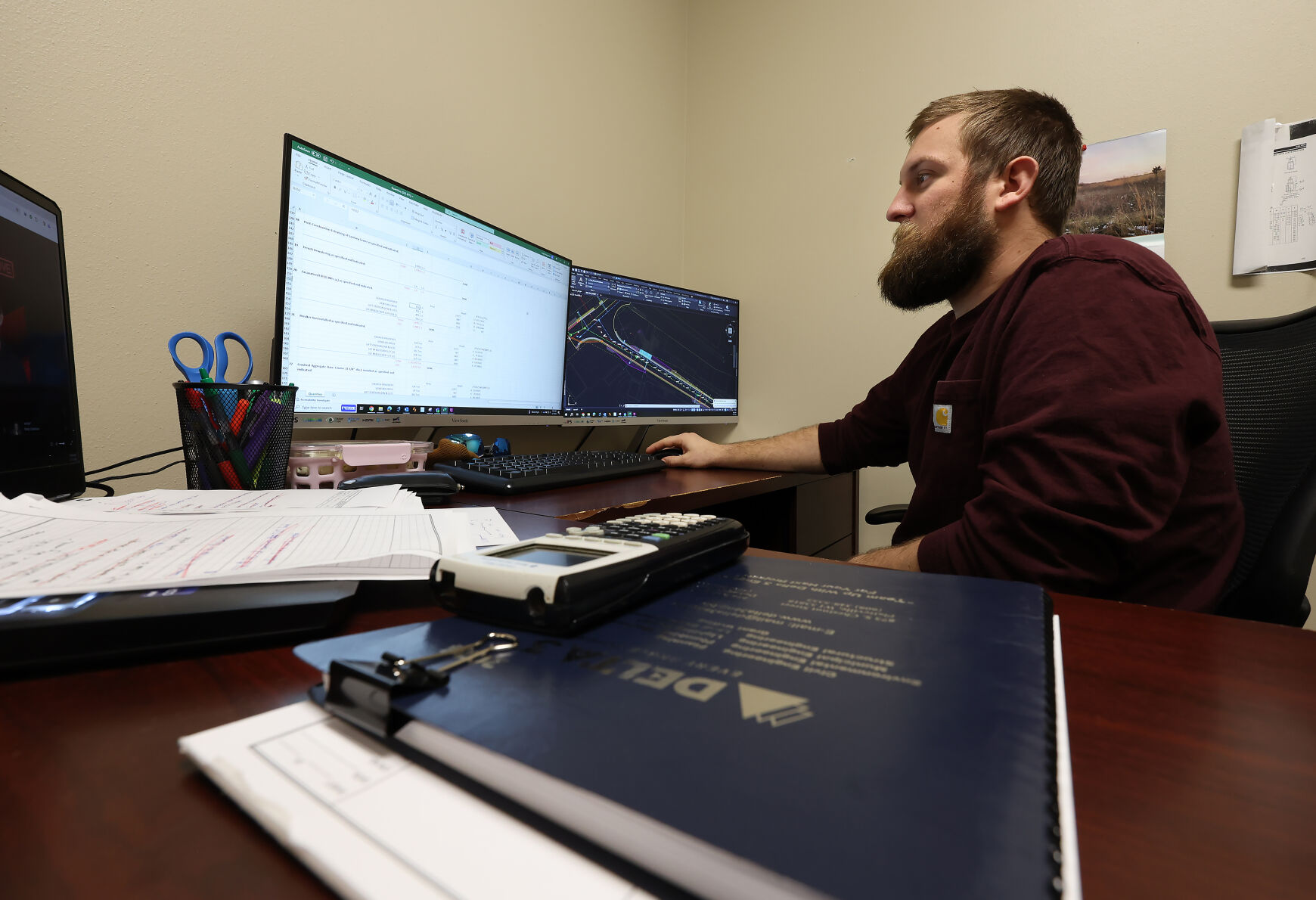 Delta 3 Engineering civil environmental engineer Logan Hoppman works on his computer at the Delta 3 office in Platteville, Wis. The company offers a variety of civil, environmental, wastewater and structural engineering services, as well surveying, grant writing and other services.    PHOTO CREDIT: Stephen Gassman
Telegraph Herald