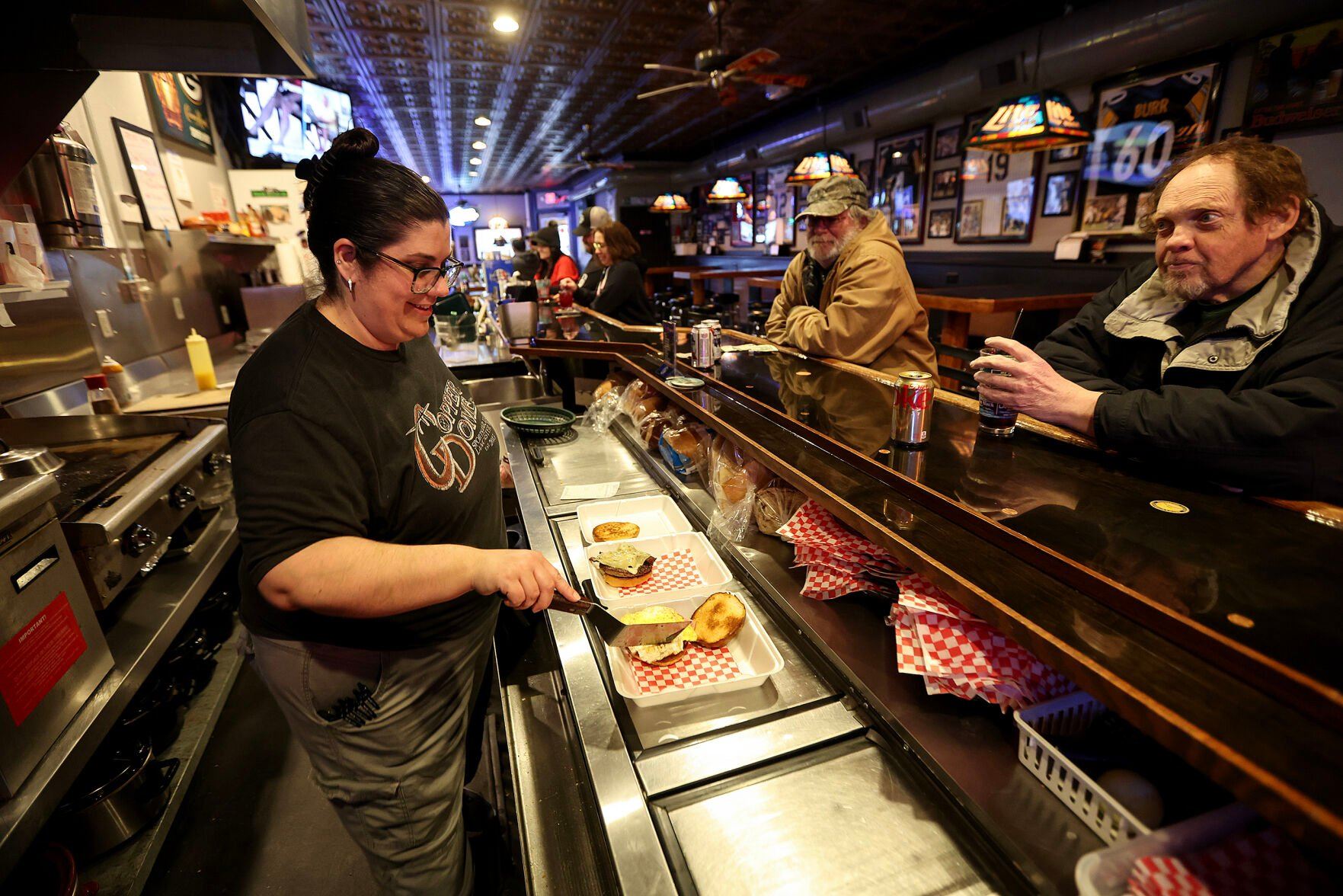 Danielle Schoenfeld works on a food order at The Dome Sports Bar in Lancaster, Wis., on Friday.    PHOTO CREDIT: Dave Kettering