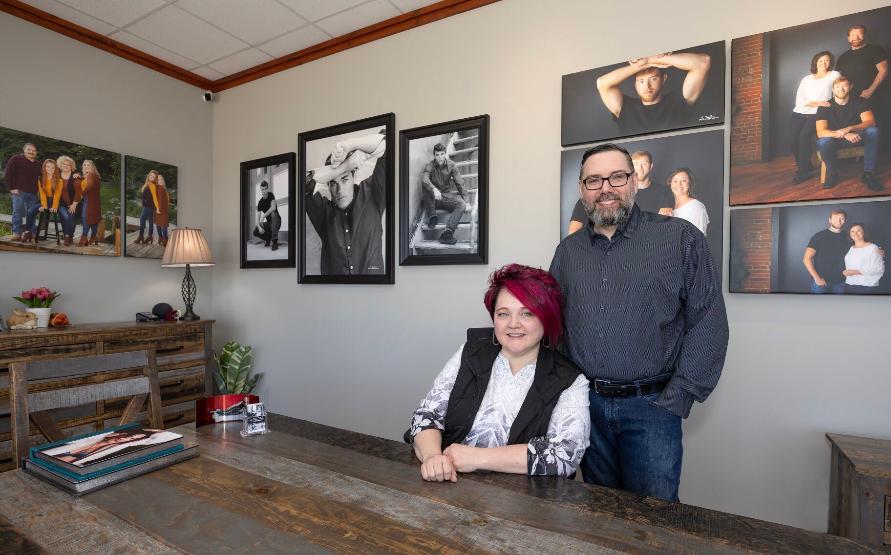Kris and Scott Kelly, co-owners of Scott Kelly Portraits, sit in their Dubuque studio on Friday.    PHOTO CREDIT: Gassman