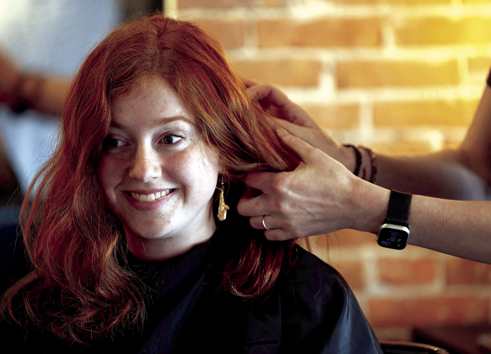 Ashley Tyson smiles as Kayla Tyson works on her hair at River City Hair Co.    PHOTO CREDIT: Stephen Gassman