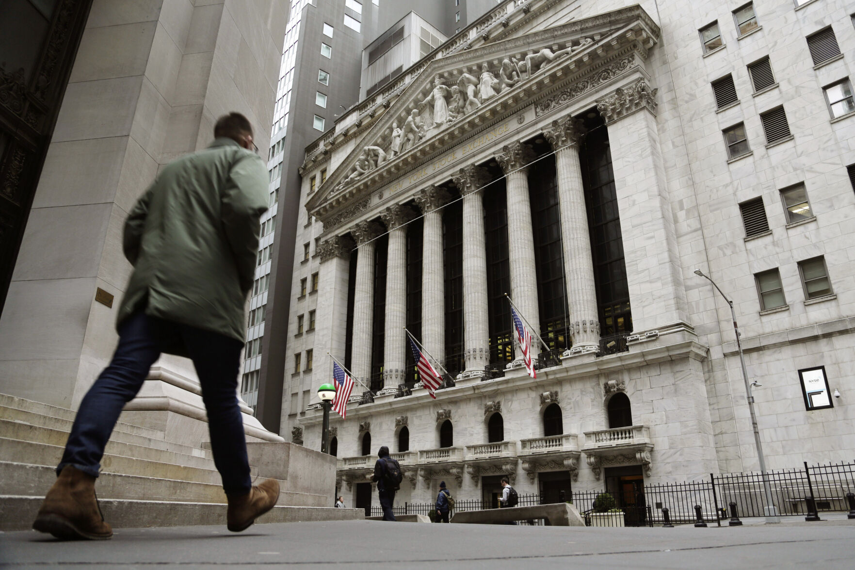 <p>FILE — People pass the front of the New York Stock Exchange, March 22, 2023. The average Wall Street bonus fell slightly last year to $176,500 as firms took a “more cautious approach” to compensation, New York state’s comptroller reported Tuesday, March 19, 2024. (AP Photo/Peter Morgan, File)</p>   PHOTO CREDIT: Peter Morgan 