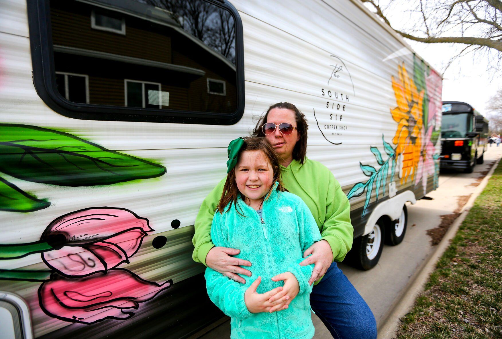 The South Side Sip owner Heather Vonderhaar is seen with her daughter, Elise Boge, in front of the business while it is parked in Dyersville, Iowa. The mobile coffee trailer serves northeast Iowa.    PHOTO CREDIT: Dave Kettering