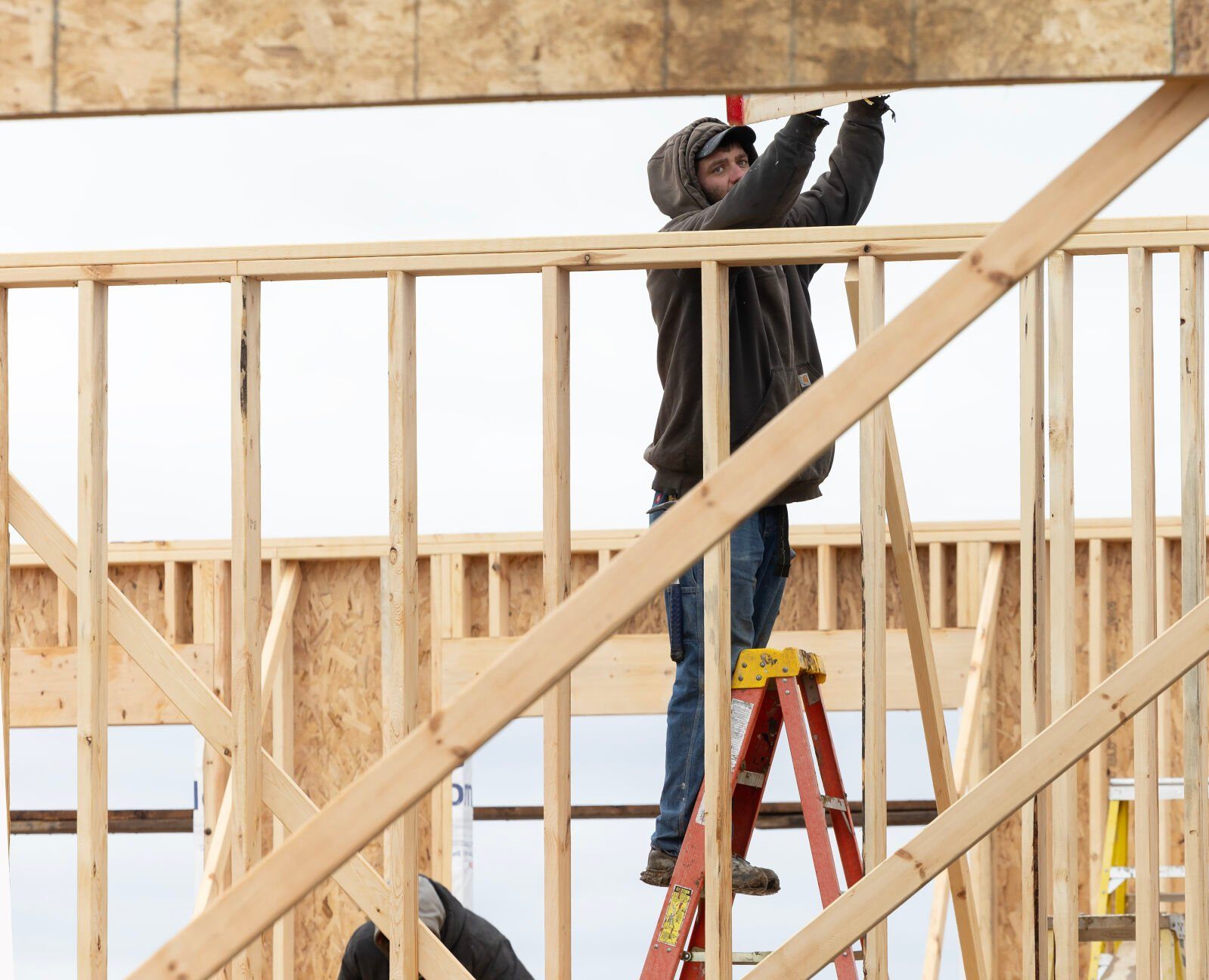 Nate Lange, with Carpenters Construction Services Inc., sets a roof joist into place at a project in Kieler, Wis.    PHOTO CREDIT: Stephen Gassman
Telegraph Herald