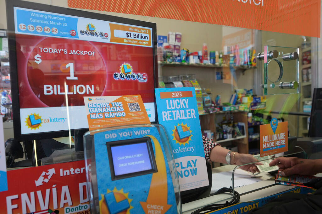 Lottery players buy Powerball tickets at the Las Palmitas Mini Market in in the Fashion District downtown Los Angeles. The Powerball jackpot has climbed to an estimated $1.09 billion after no one matched the latest numbers.     PHOTO CREDIT: Damian Dovarganes
