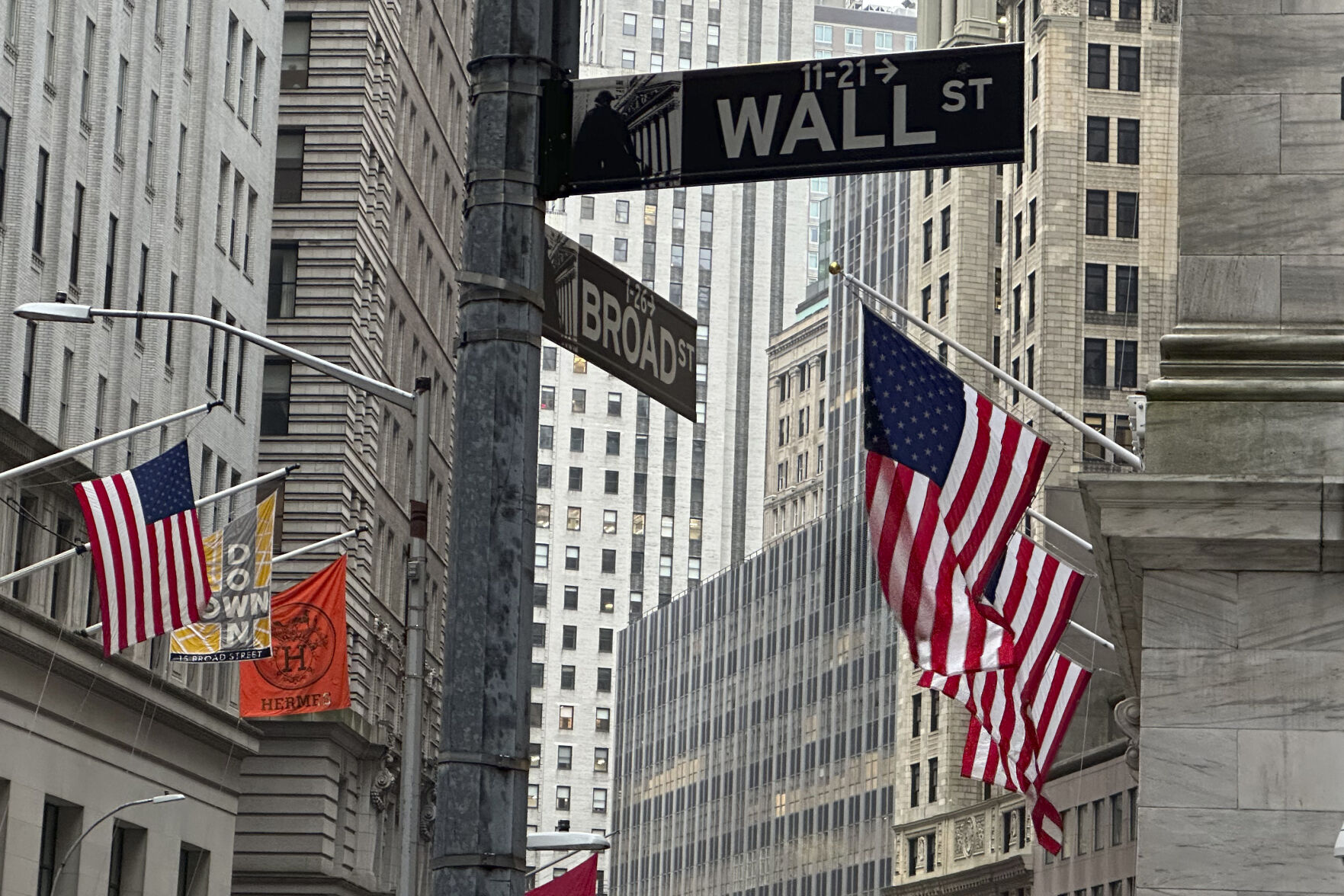<p>American flags hang from the front the New York Stock Exchange, right, on Thursday, April 11, 2024 in New York. Shares in Europe and Asia are mostly lower after U.S. stocks fell following another release of hotter than expected inflation data. (AP Photo/Peter Morgan)</p>   PHOTO CREDIT: Peter Morgan - staff, ASSOCIATED PRESS