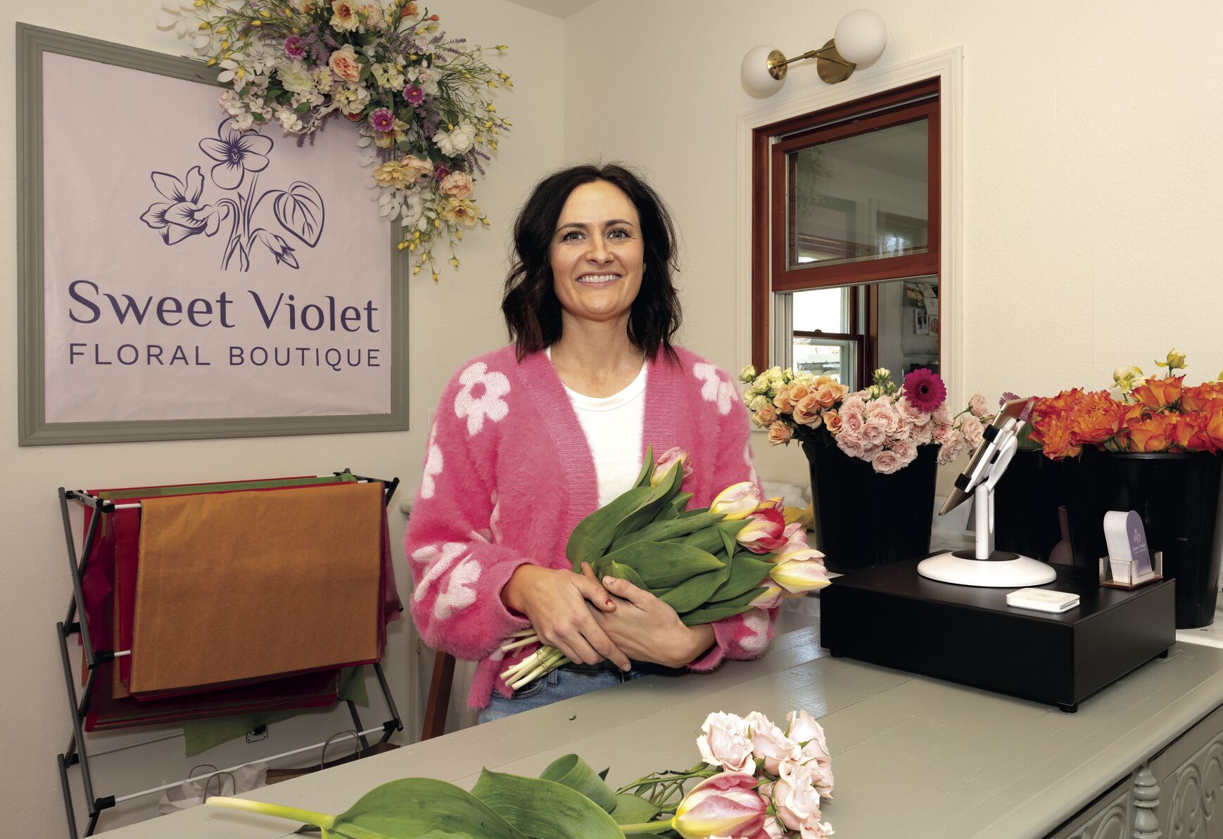 Owner Ellen Pinnola stands behind the counter at Sweet Violet Floral Boutique at 140 S. Water St. in Platteville, Wis., on Friday.    PHOTO CREDIT: Stephen Gassman