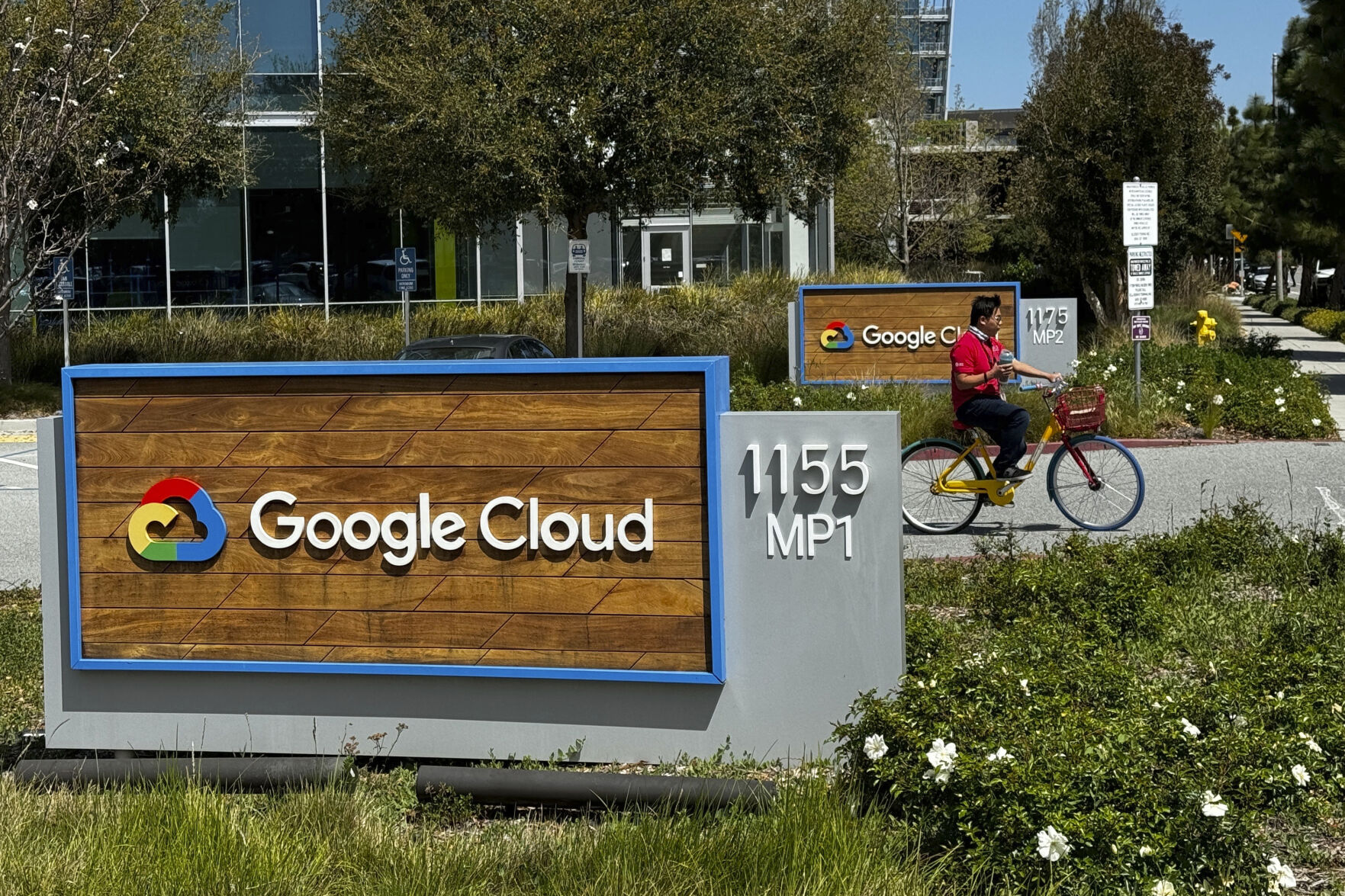 A person rides past the Google sign outside the Google offices in Sunnyvale, Calif., on Thursday, April 18, 2024. Google has fired 28 employees who were involved in protests over the tech company’s cloud computing contract with the Israeli government. The workers held sit-ins at the company’s offices in California and New York over Google’s $1.2 billion contract to provide custom tools for Israeli’s military. (AP Photo/Terry Chea)    PHOTO CREDIT: Associated Press