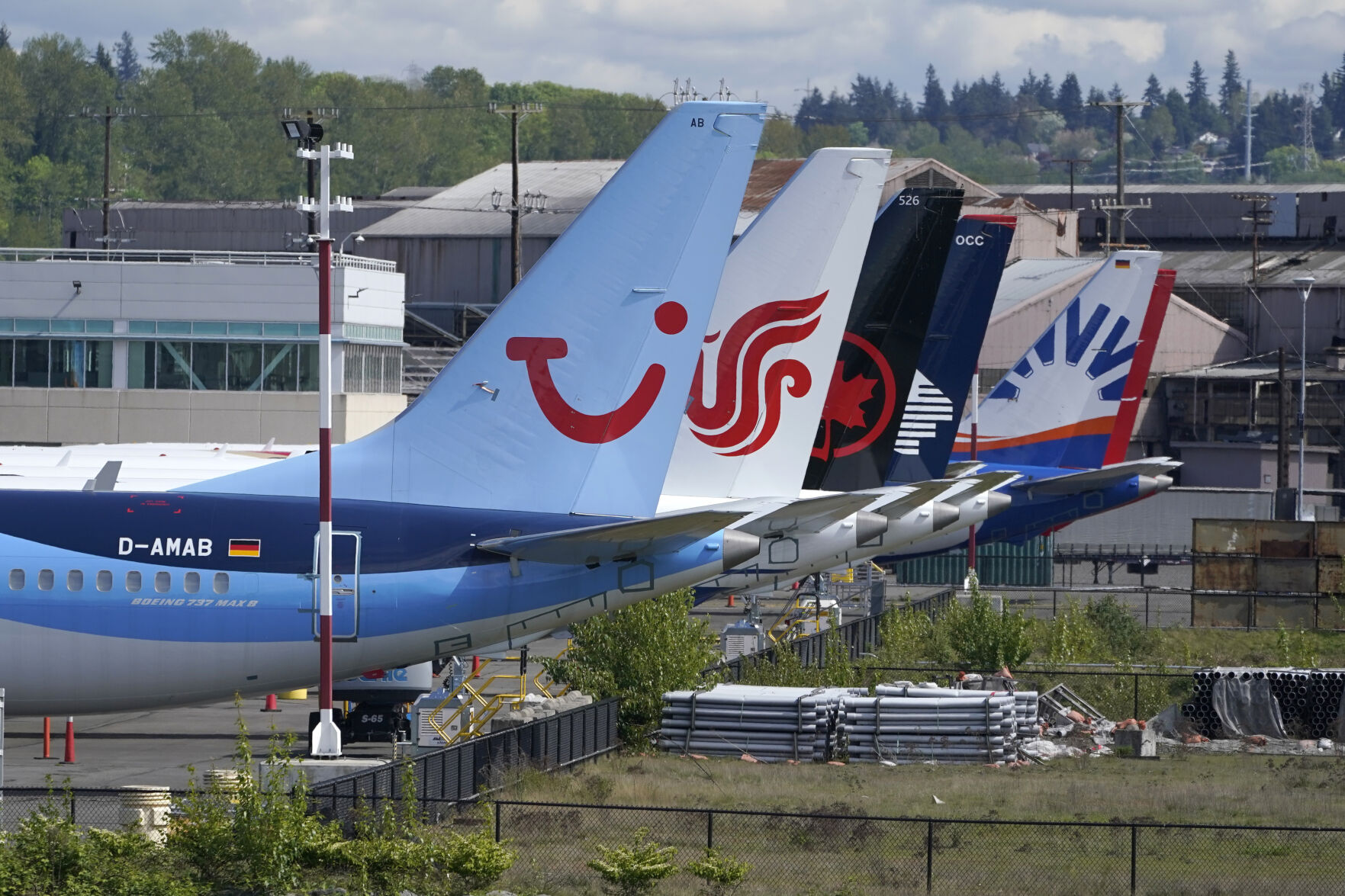 <p>FILE - Boeing 737 Max airplanes, including one belonging to TUI Group, left, sit parked at a storage lot, Monday, April 26, 2021, near Boeing Field in Seattle. Boeing reports earnings on Wednesday, April 24, 2024. (AP Photo/Ted S. Warren, File)</p>   PHOTO CREDIT: Ted S. Warren 