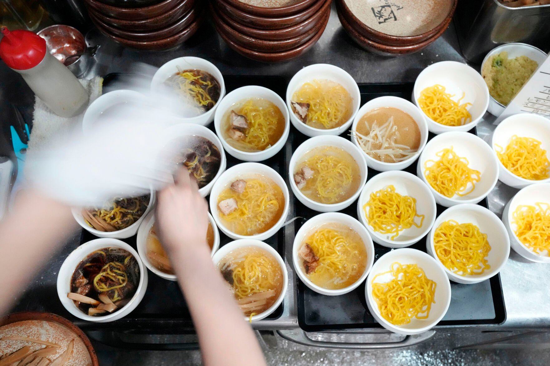 <p>A staff member prepares small bowls of noodle for participants of Tokyo Ramen Tours at Shinbusakiya, a ramen shop which offers "Hokkaido classics," at Shibuya district on April 2, 2024, in Tokyo. (AP Photo/Eugene Hoshiko)</p>   PHOTO CREDIT: Eugene Hoshiko 