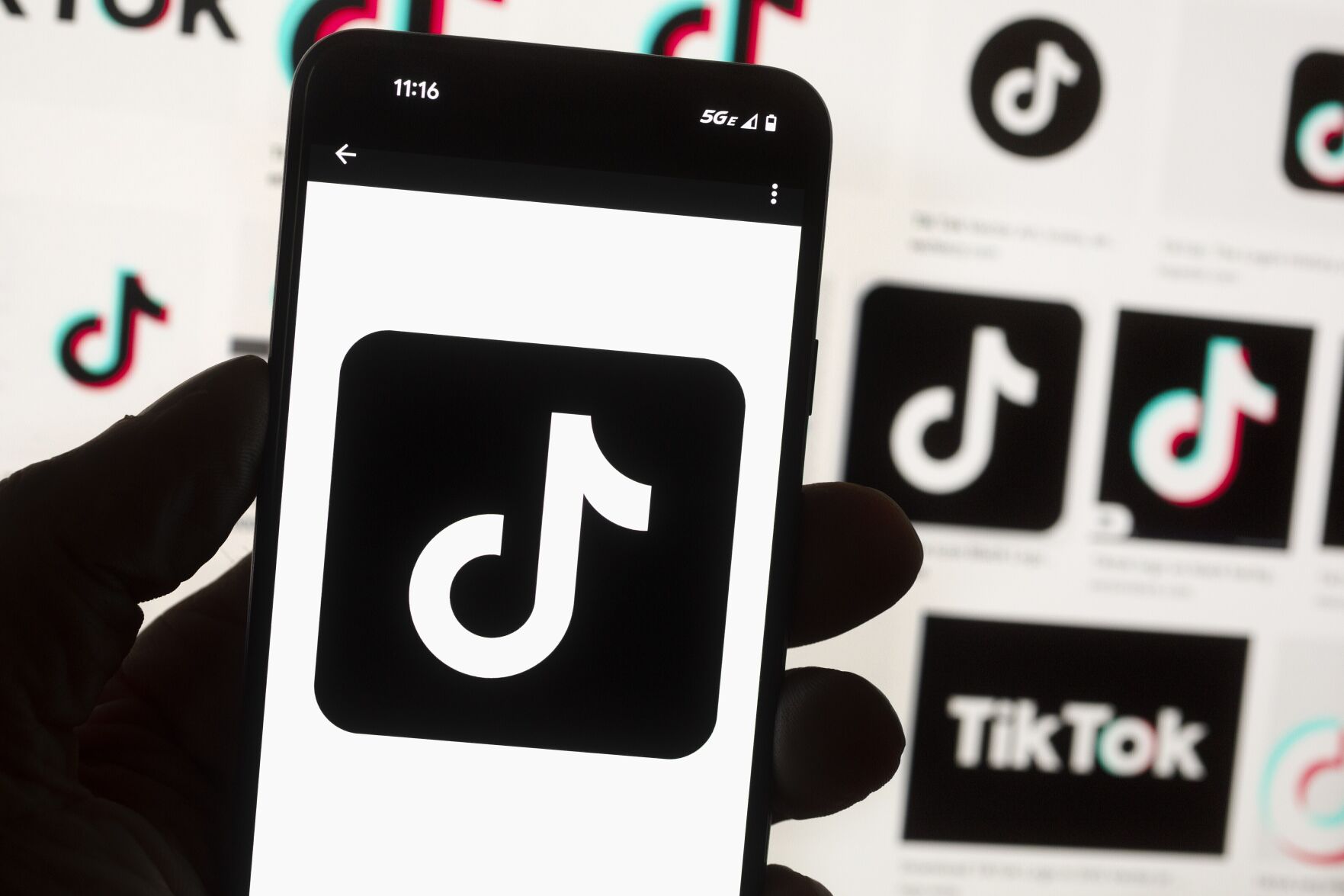 <p>FILE - The TikTok logo is displayed on a mobile phone in front of a computer screen, Oct. 14, 2022, in Boston. TikTok is gearing up for a legal fight against a U.S. law that would force the social media platform to break ties with its China-based parent company or face a ban. A battle in the courts will almost certainly be backed by Chinese authorities as the bitter U.S.-China rivalry threatens the future of a wildly popular way for young Americans to connect online. (AP Photo/Michael Dwyer, File)</p>   PHOTO CREDIT: Michael Dwyer - staff, ASSOCIATED PRESS