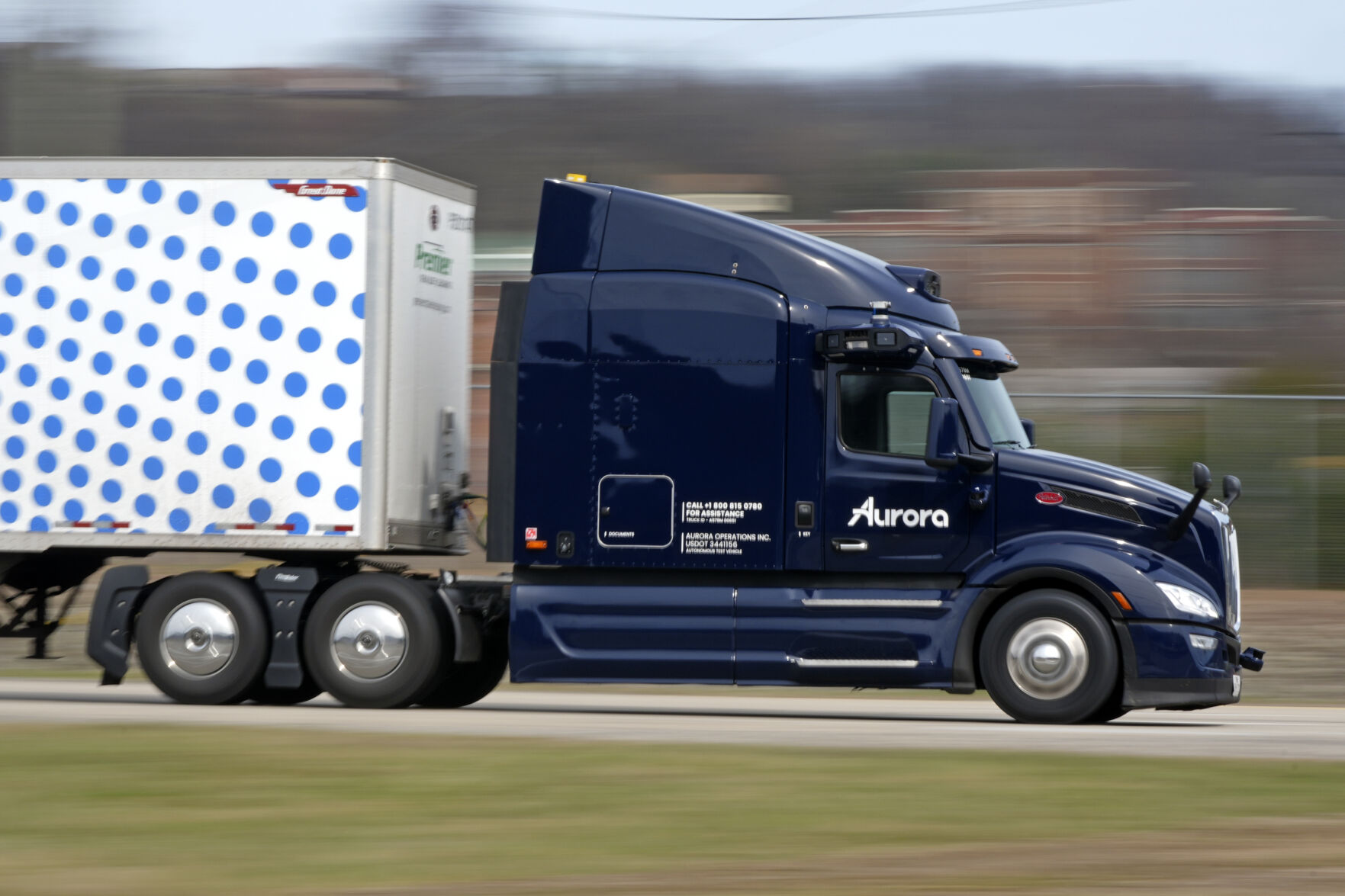 <p>A self-driving tractor trailer maneuvers around a test track in Pittsburgh, Thursday, March 14, 2024. The truck is owned by Pittsburgh-based Aurora Innovation Inc. Late this year, Aurora plans to start hauling freight on Interstate 45 between the Dallas and Houston areas with 20 driverless trucks. (AP Photo/Gene J. Puskar)</p>   PHOTO CREDIT: Gene J. Puskar 