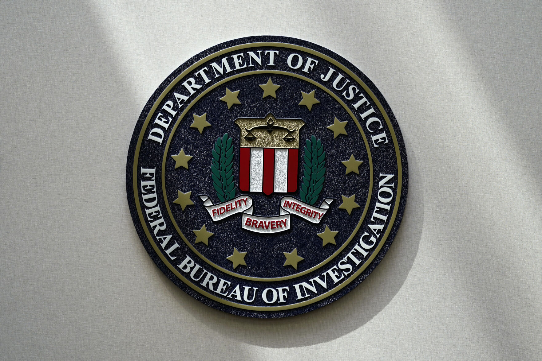 <p>FILE - An FBI seal is seen on a wall on Aug. 10, 2022, in Omaha, Neb. The FBI says scammers stole more than $3.4 billion from older Americans last year. An FBI report released Tuesday shows a rise in losses through increasingly sophisticated tactics to trick the vulnerable into giving up their life savings. (AP Photo/Charlie Neibergall, File)</p>   PHOTO CREDIT: Charlie Neibergall 