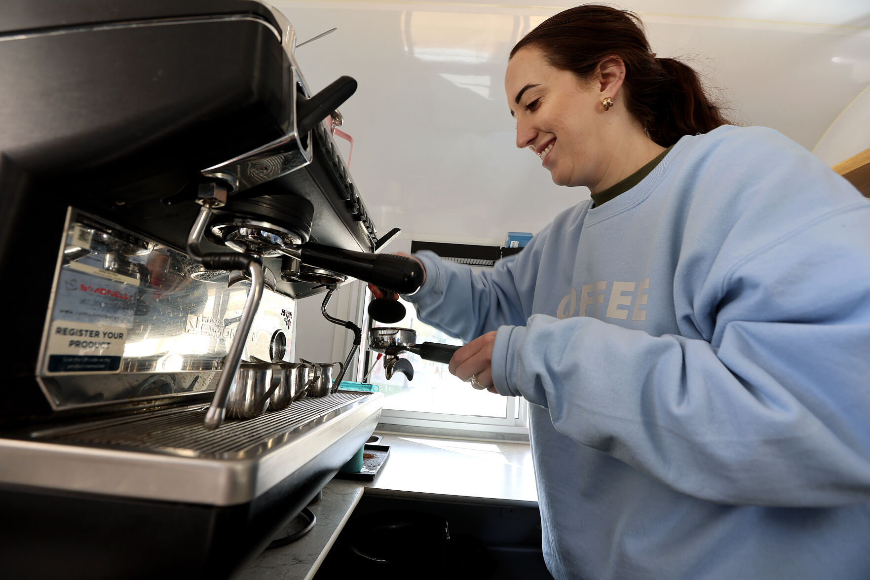 Sarah Knabel, owner of Bob & Lou’s, pulls shots of expresso for a coffee order.    PHOTO CREDIT: Dave Kettering
