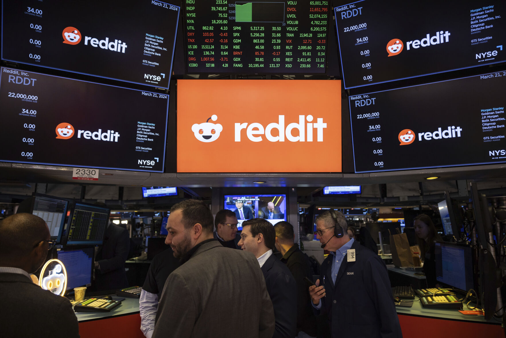 FILE - Reddit Inc. signage is seen on the New York Stock Exchange trading floor, prior to Reddit IPO, Thursday, March. 21, 2024. OpenAI and Reddit are teaming up in a deal that will bring the social media platform
